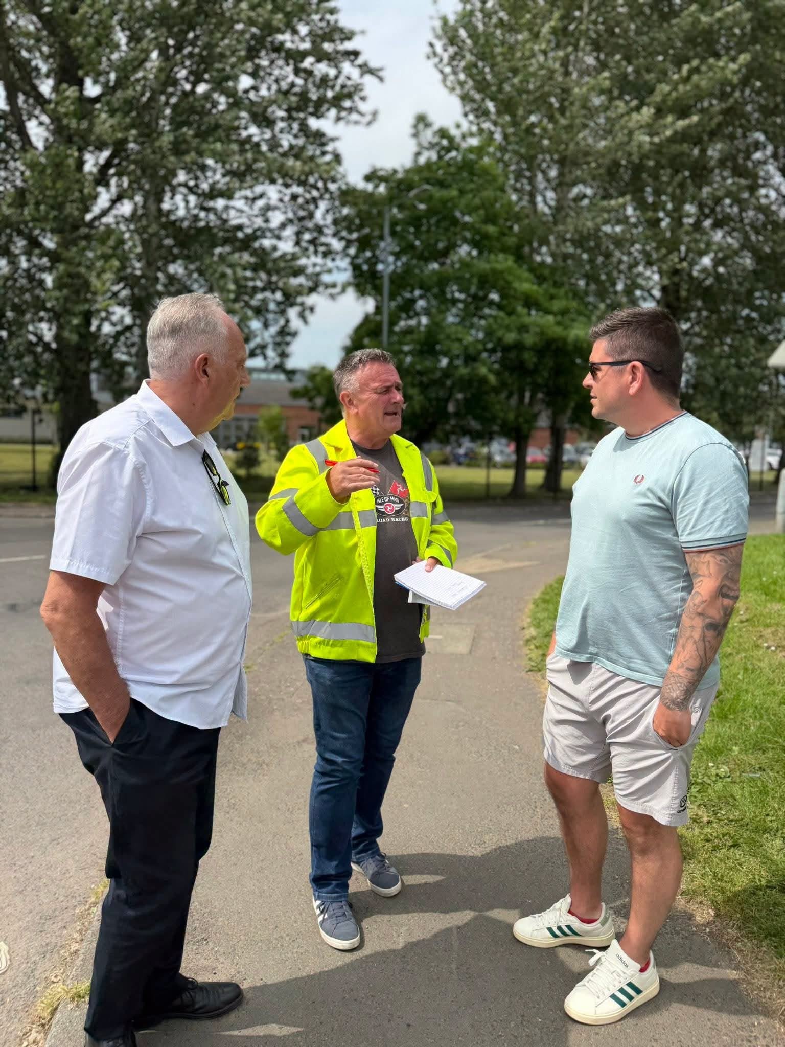 RESURFACING WORKS: Councillor Séanna Walsh and Danny Baker MLA with a DfI official 