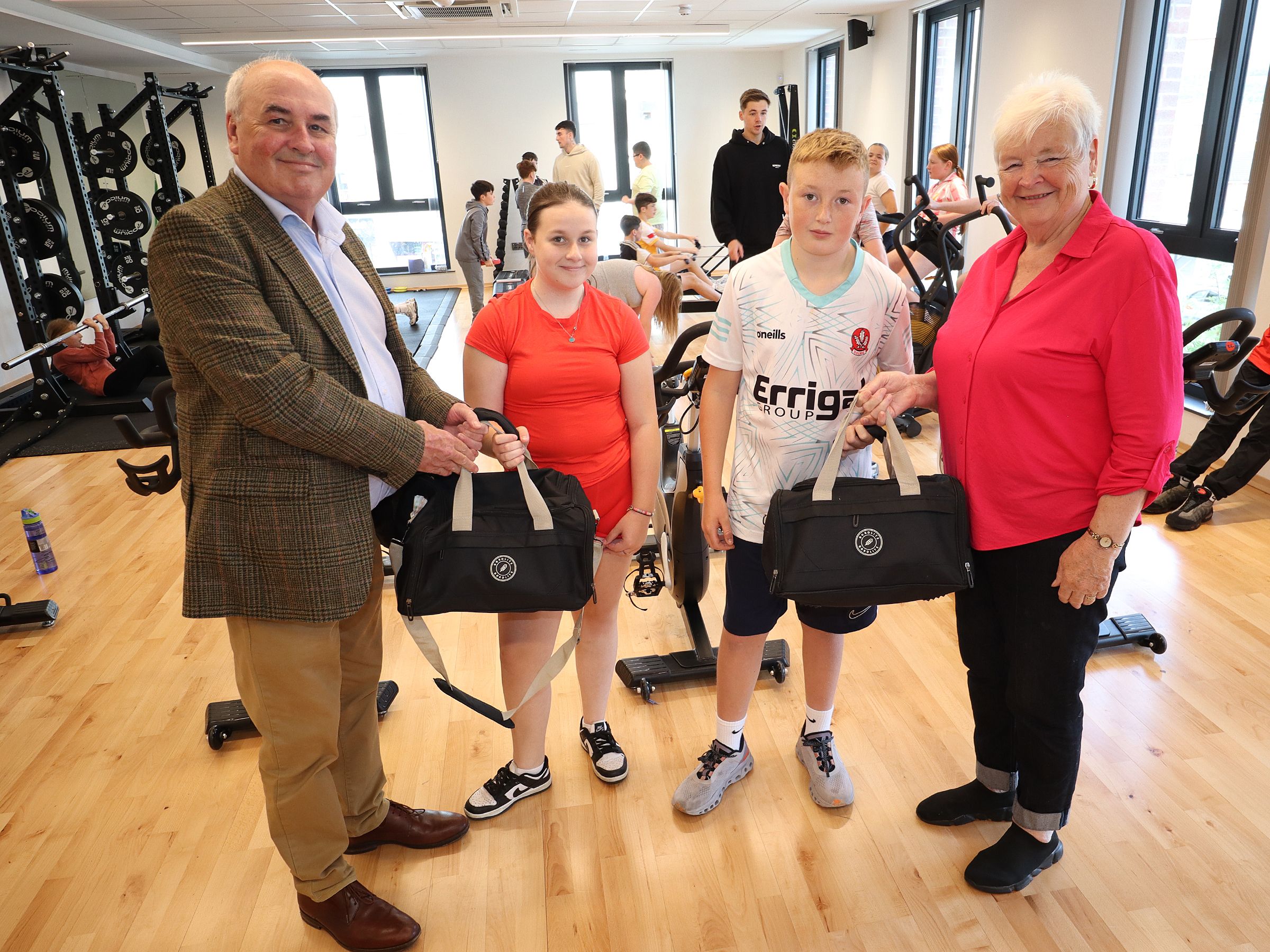 Housing Executive’s Seán Brennan with Katiesharon, Ronan and Ardoyne Association Chairperson Marian Kane