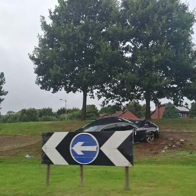 Man charged after car mounts Stewartstown Road roundabout