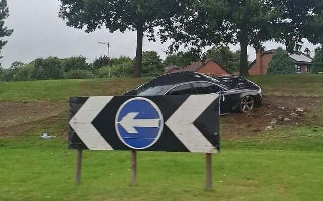 Man charged after car mounts Stewartstown Road roundabout