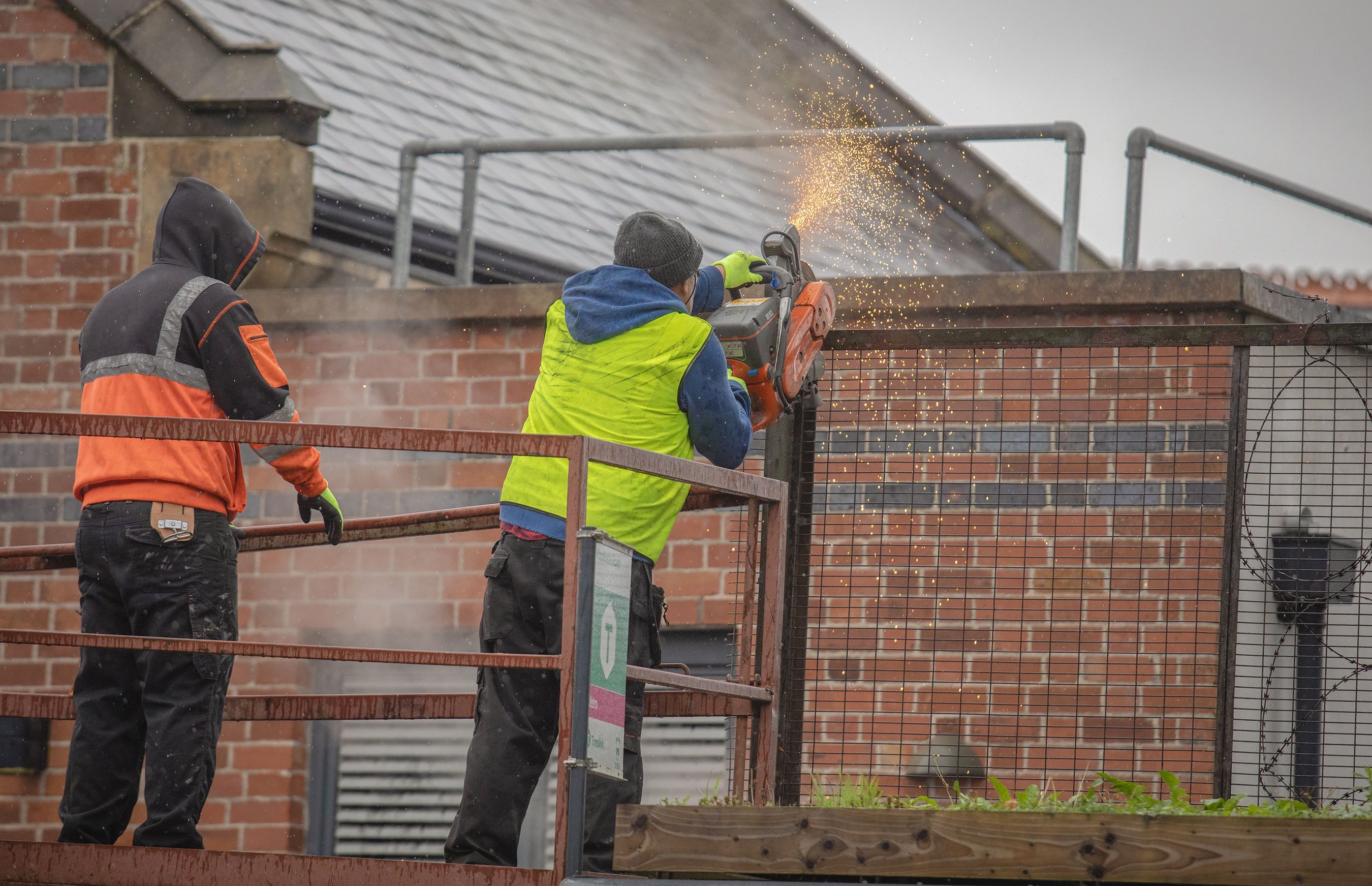 REMOVAL: The fencing at Holy Cross Church being removed on Wednesday morning