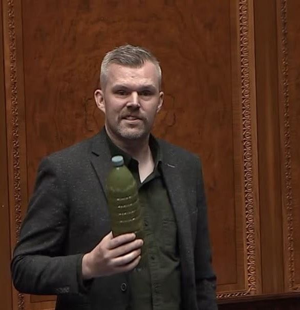 GOING GREEN: West Belfast MLA Gerry Carroll in the Stormont chamber on Tuesday