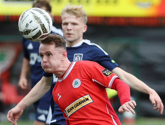TIGHT: Liam McStravick competes for the ball