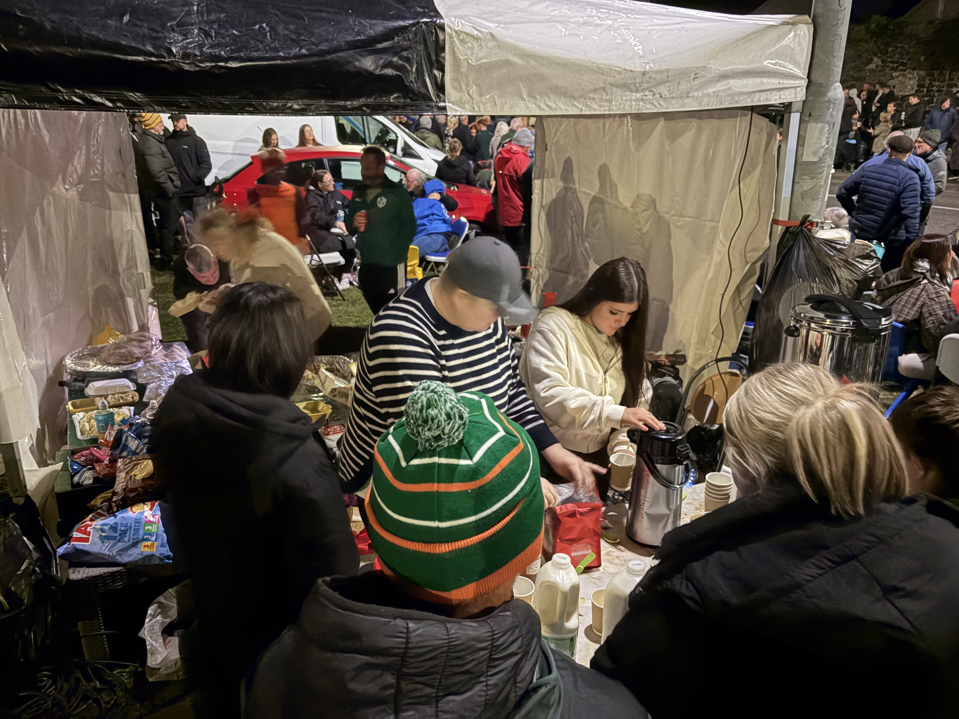 NIGHT WATCH: Volunteers serving up tea and sandwiches to cold and famished protesters as night fell on the Garvaghy Road this Monday