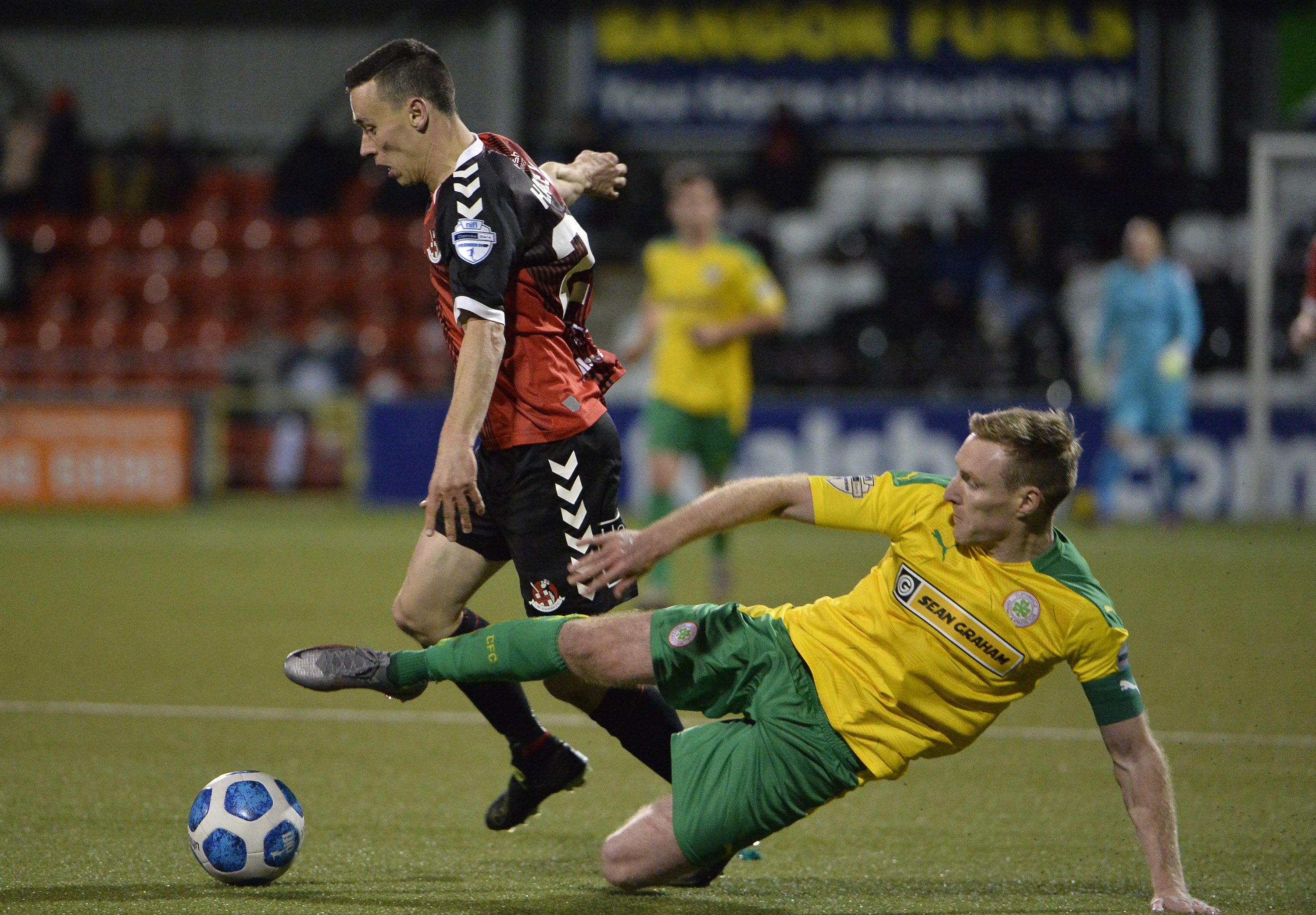Paul Heatley is challenged by Cliftonville's Chris Curran
