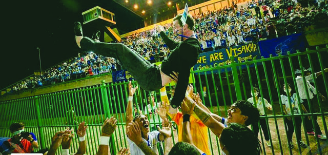 Vishaka players celebrate with their Belfast manager following the victory over NagaWorld FC earlier this month
