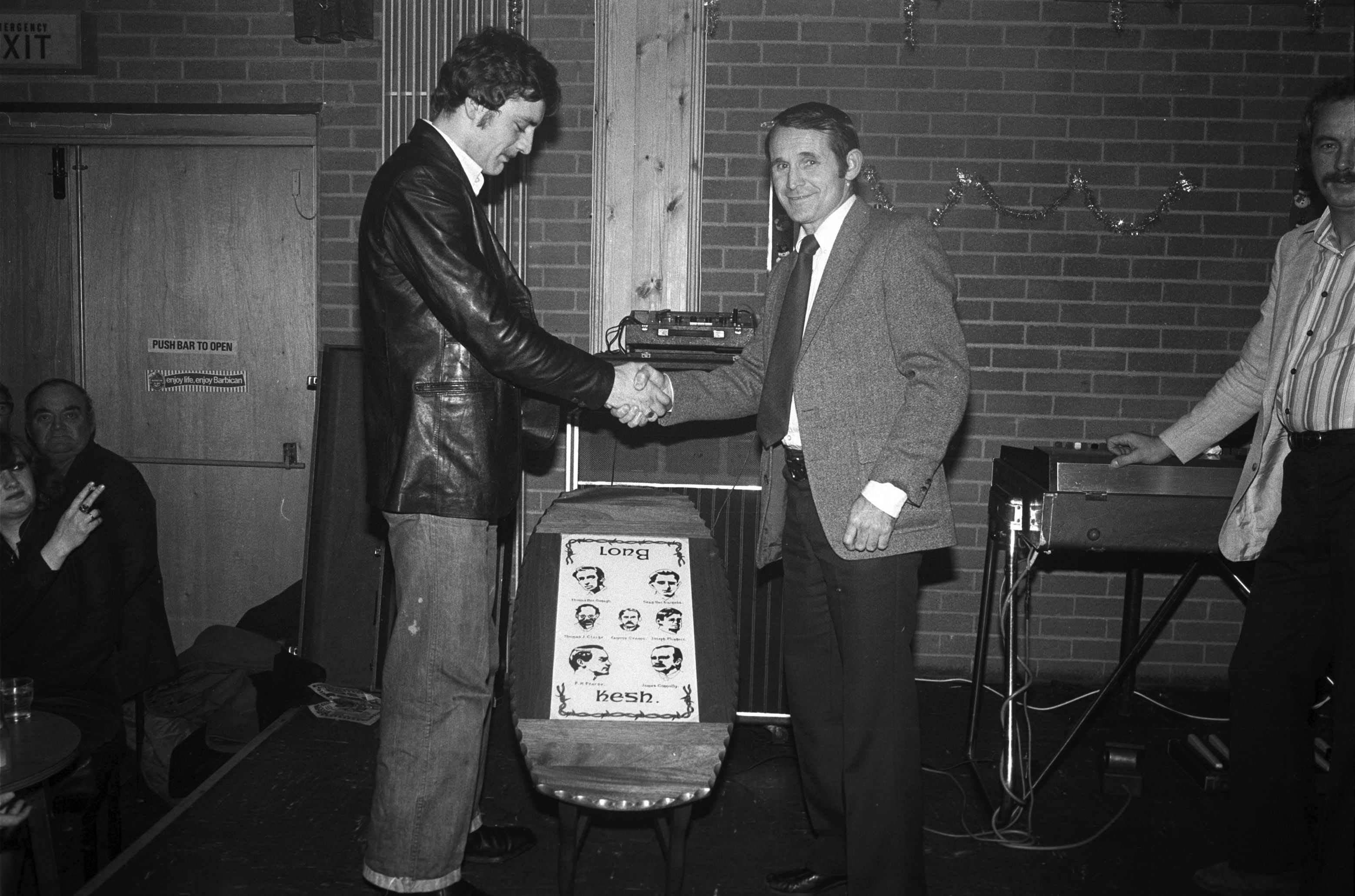 Mr Hanna wins a table made in Long Kesh. Jim Nelson, St Paul's GAC and Antrim County Hurling Board, shakes his hand