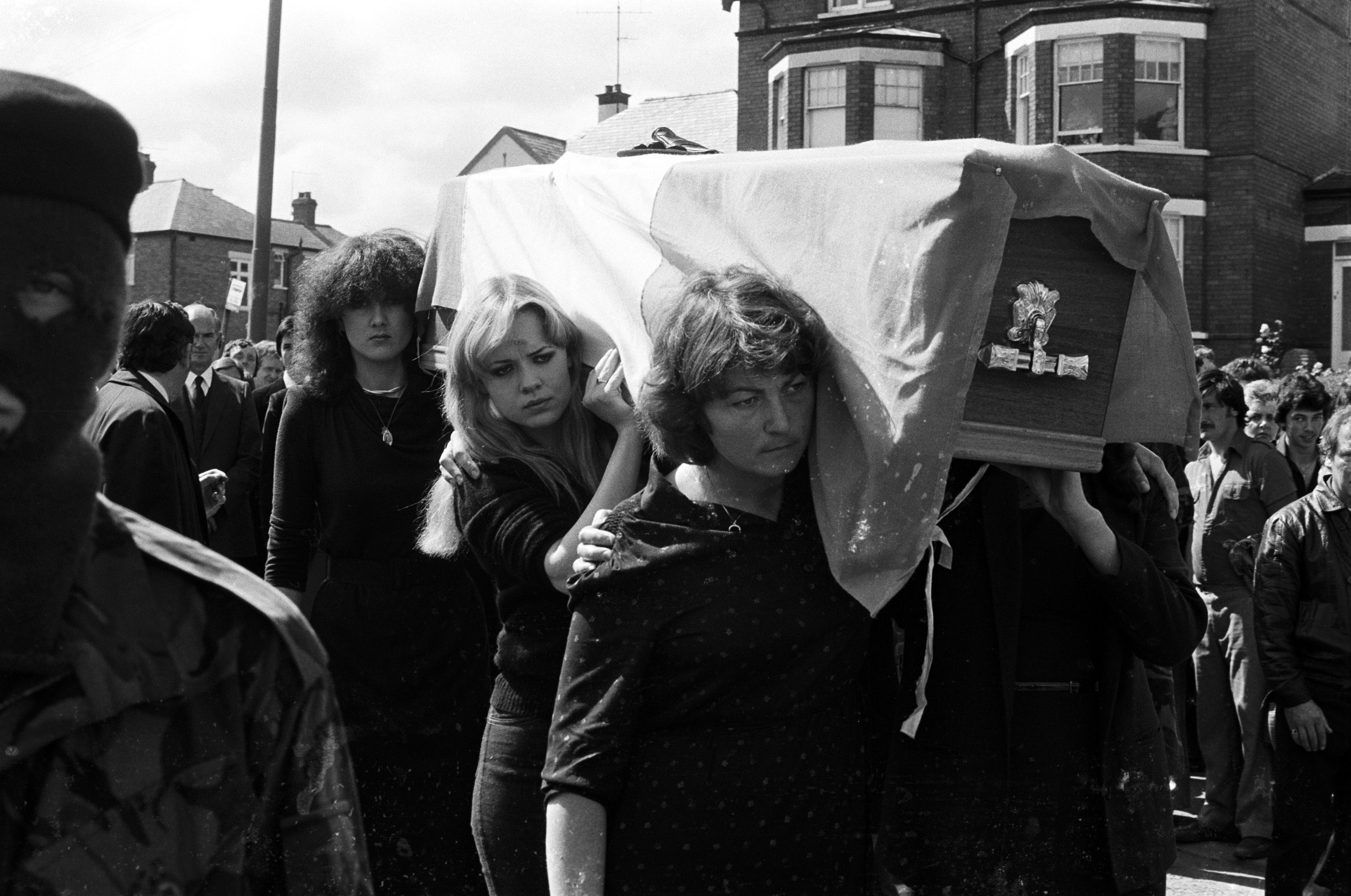 FINAL JOURNEY: Kieran's sisters Mairéad and Siobhán McKenna and sister-in-law Betty Doherty carrying his coffin on the way to Milltown Cemetery