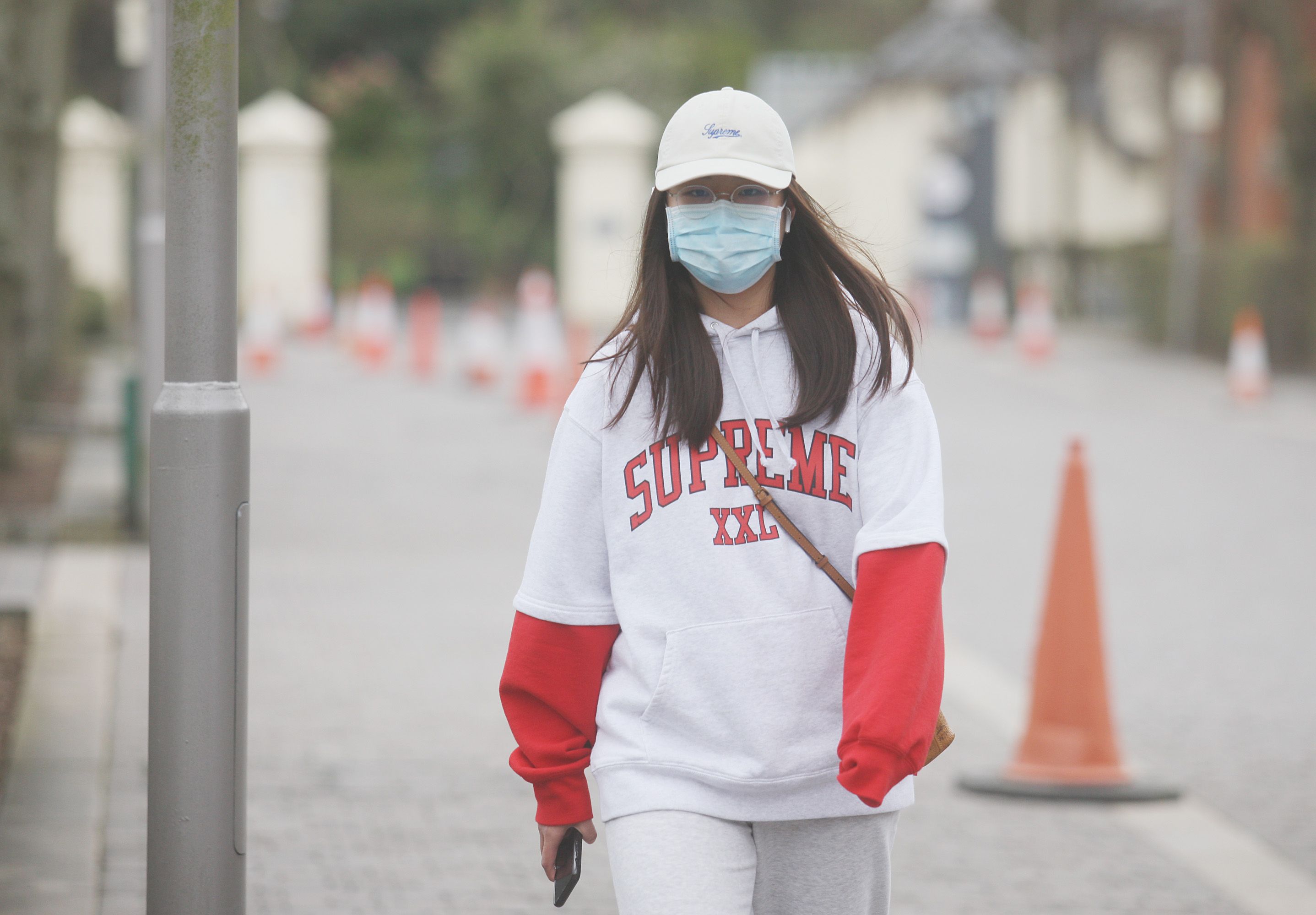 CRISIS CONTINUES: A pedestrian in South Belfast sporting a mask to protect against coronavirus spread