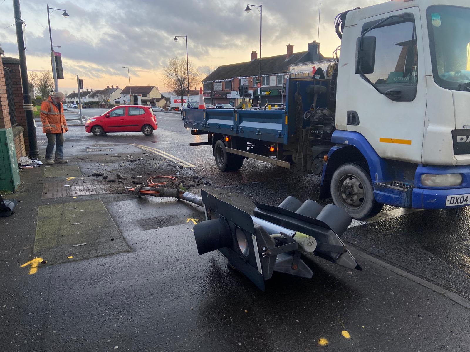 AFTERMATH: Damaged traffic lights are removed from the scene of the collision on Monday morning