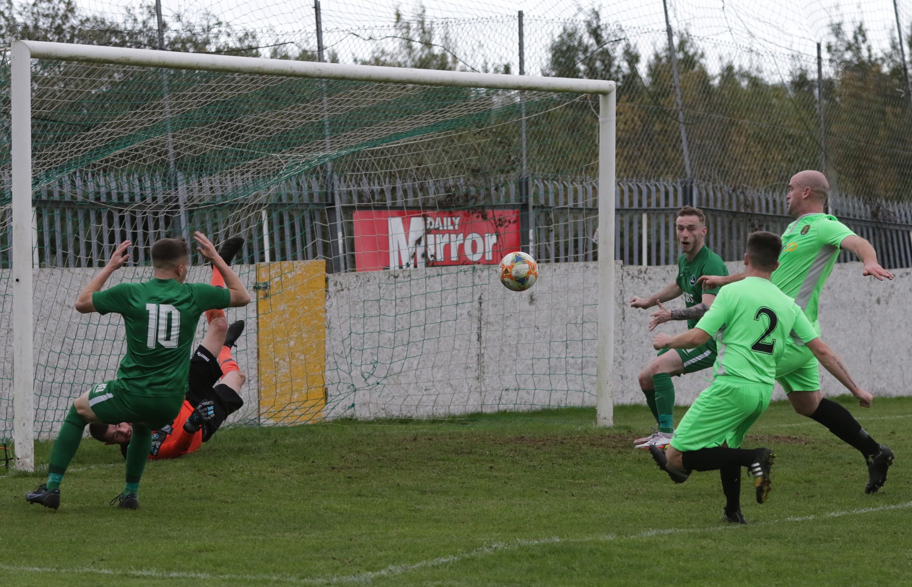Belfast Celtic goalkeeper Paul McLaughlin makes a superb save to deny Patrick Downey in an action-packed first half