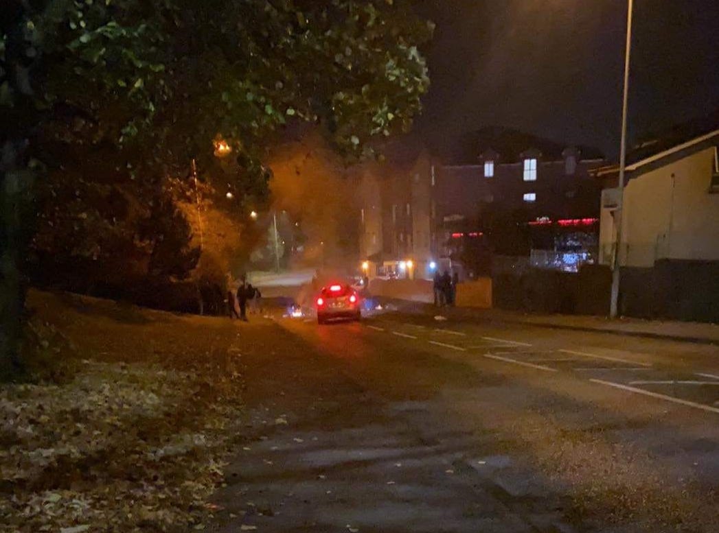 A car navigated flaming debris on the Bell Steel Road
