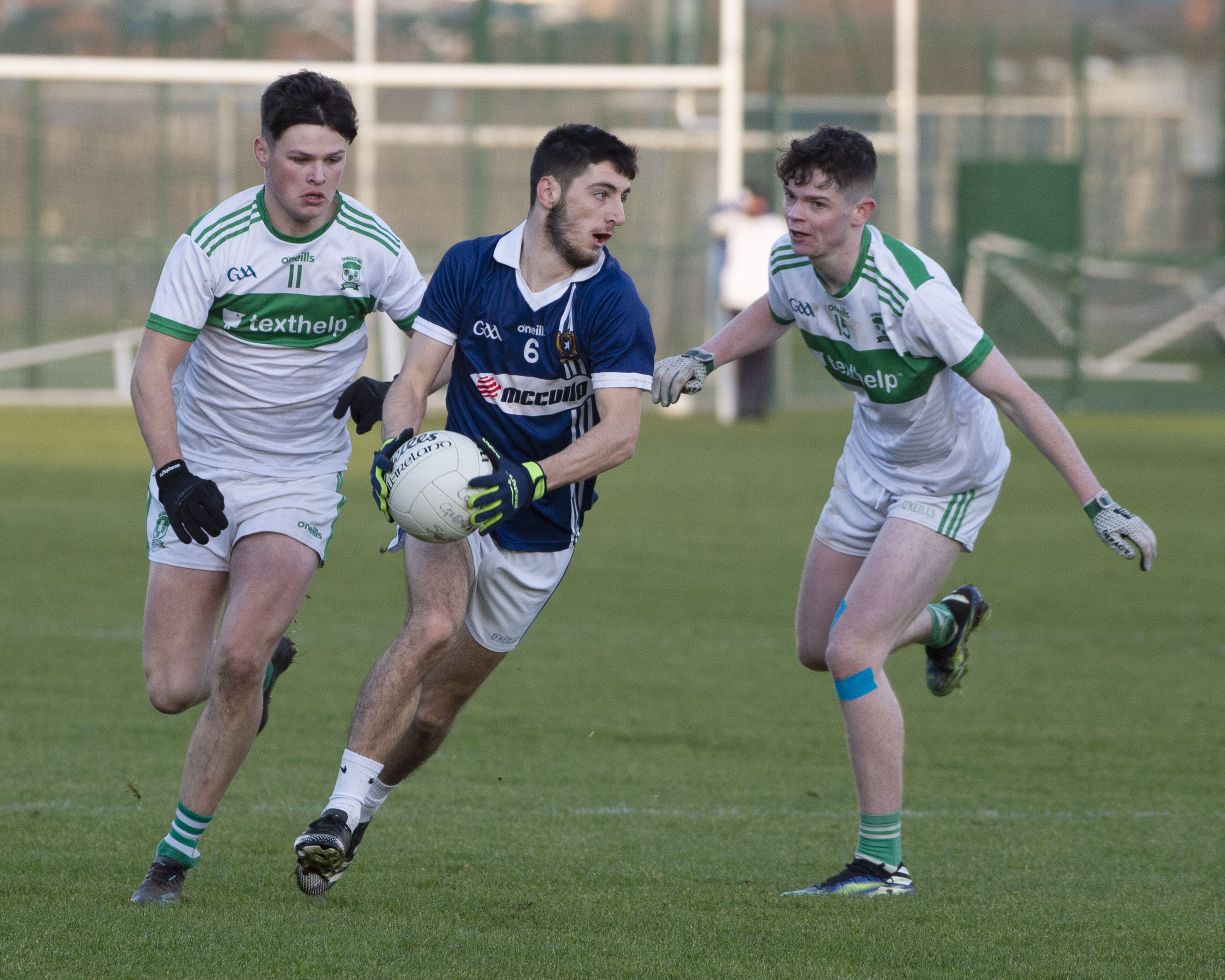 Conor Ryan skips away from Rian Lennon and Darragh Donnelly