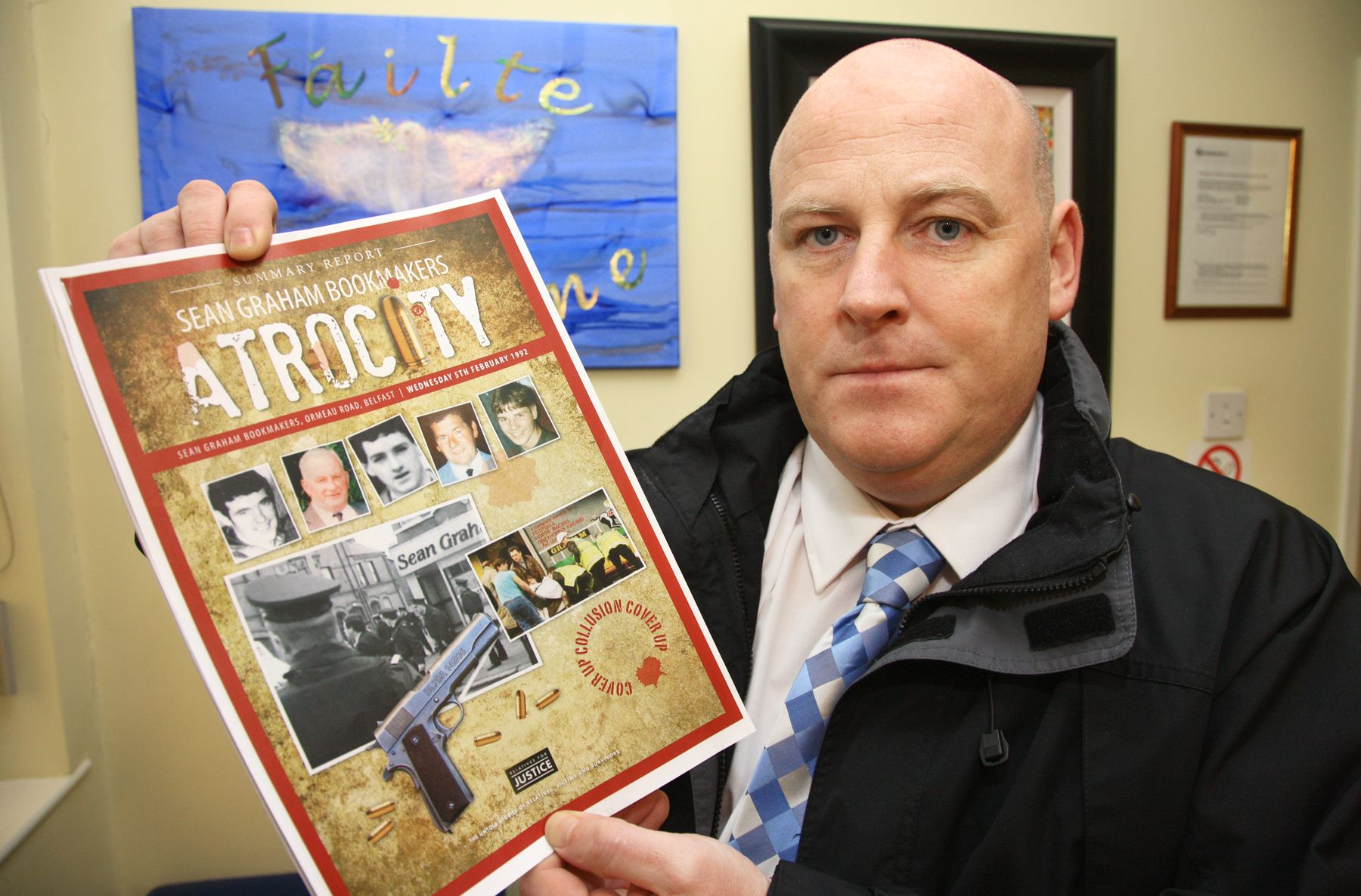 ARRESTED: Bookmaker's massacre survivor Mark Sykes with a copy of a report into collusion by RUC with the UDA killers