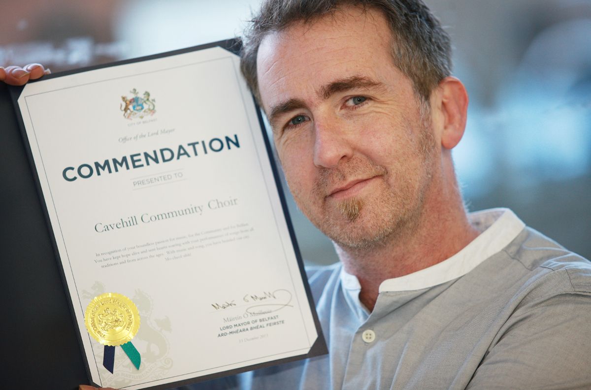 ON SONG: Paul Carlin showing off a Commendation from City Hall back in 2014 to recognise the work of Cavehill Community Choir