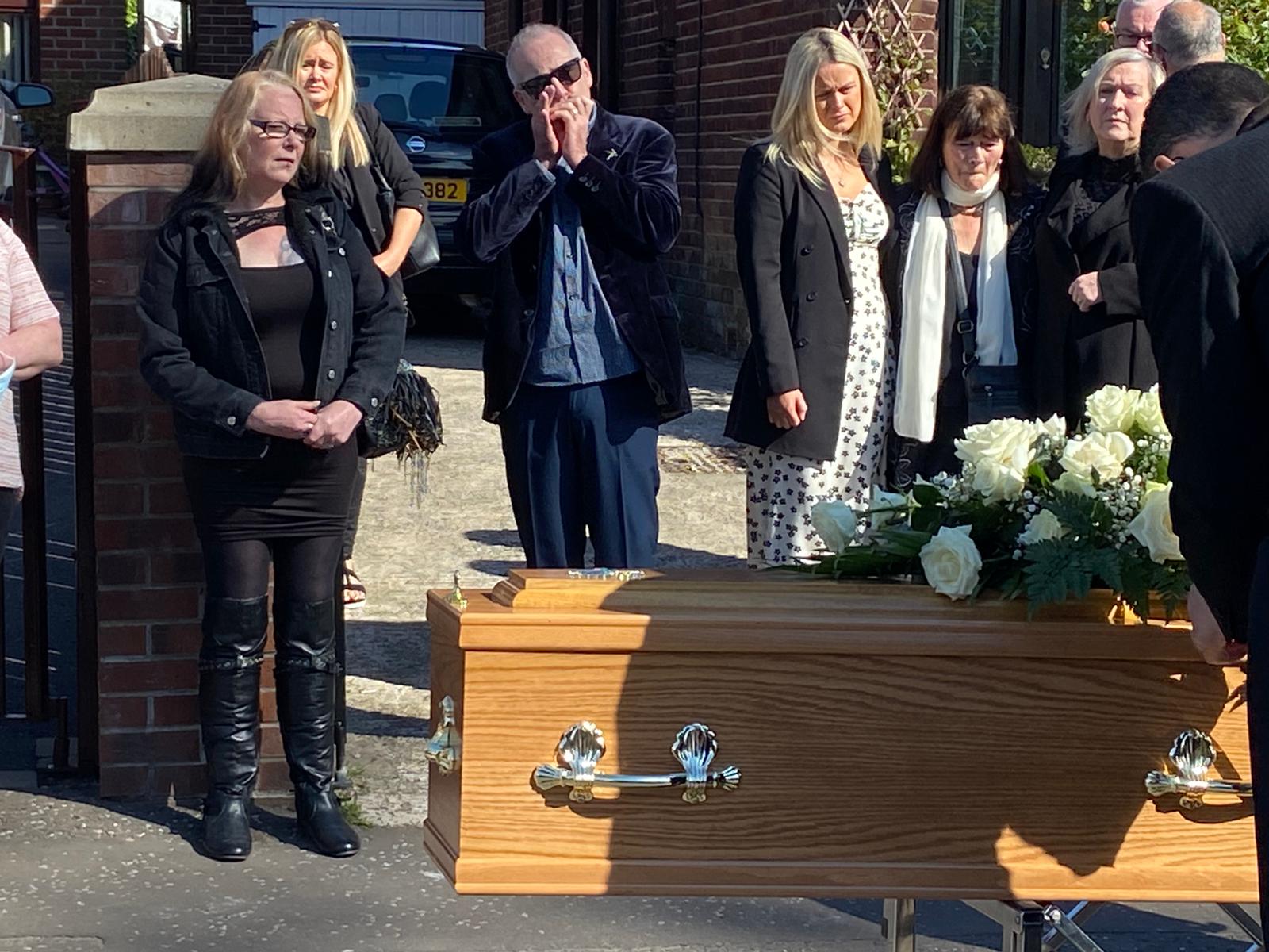 LAMENT: Musician Rev Doc plays a final tribute as Rab McCullough's remains are taken to St Agnes' Church