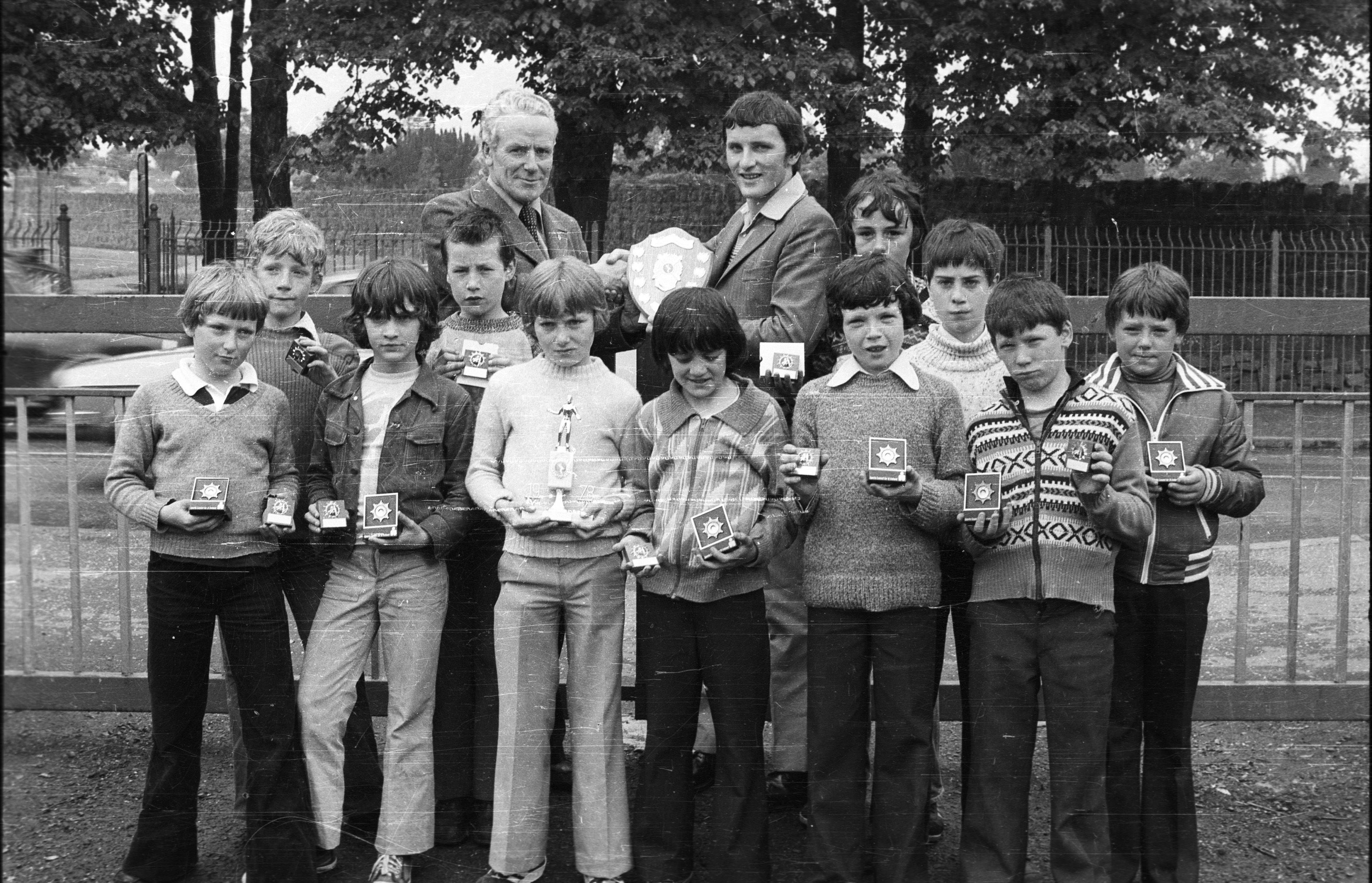 Paul McGreevy presents the trophy to Paul McGreevy for St Kevin's at the Primary Schools handball competition at Beechmount Leisure Centre