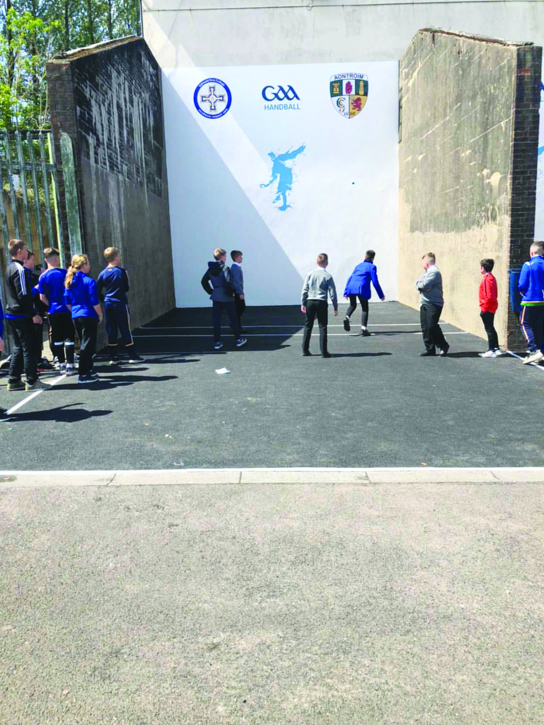 Kids enjoying handball at the restored courts