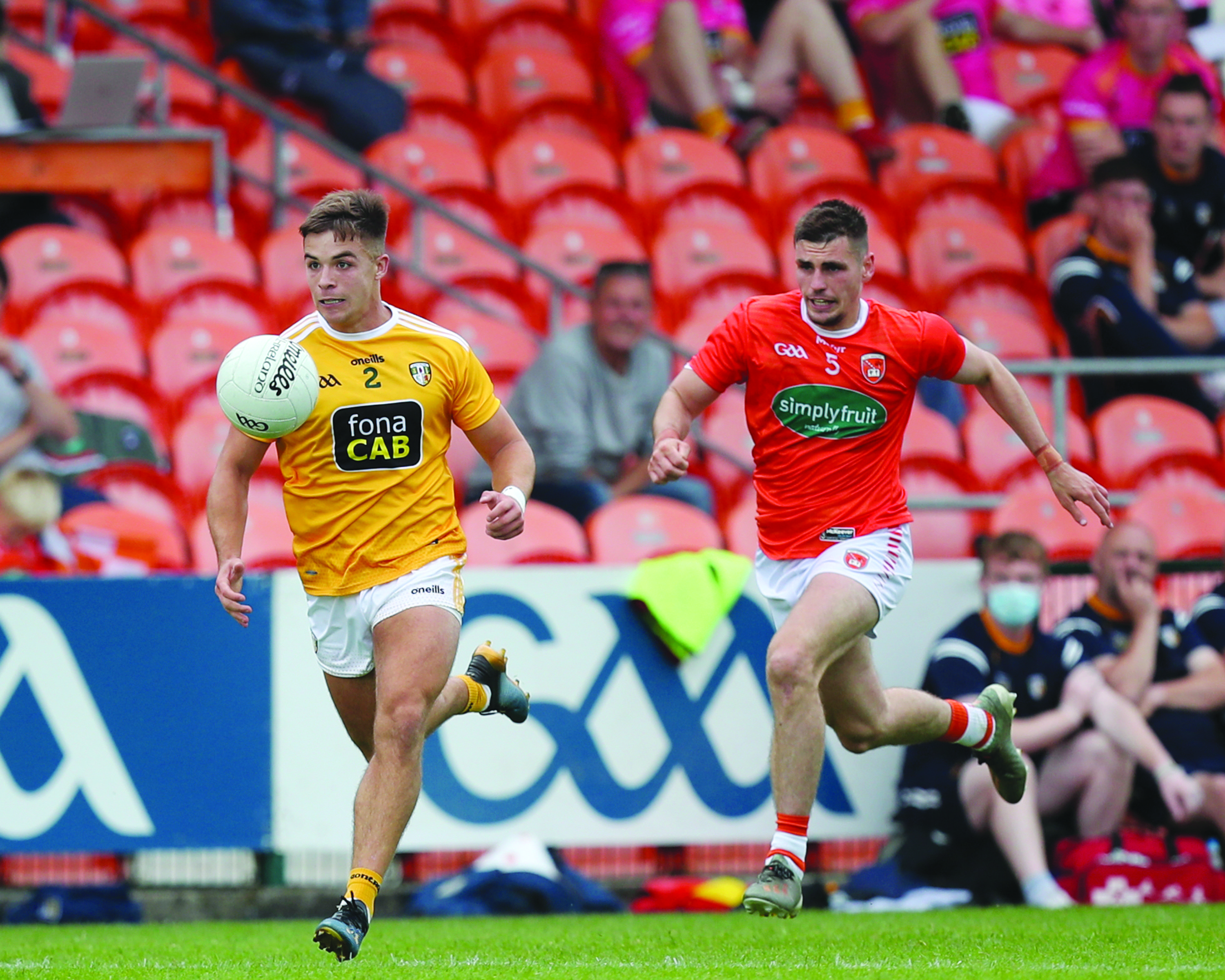 Antrim defender Eoghan McCabe sprints clear of Armagh’s Greg McCabe 