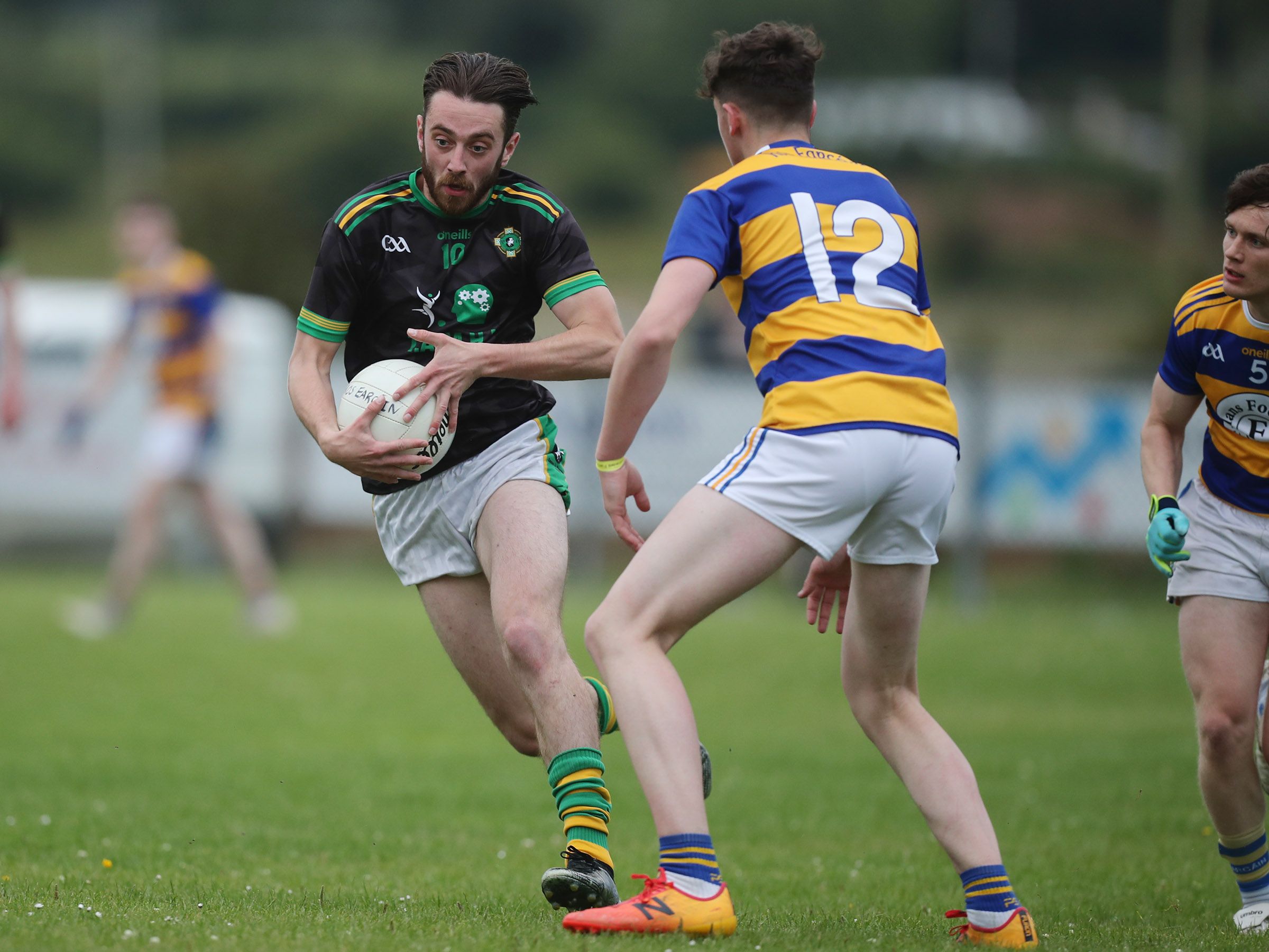 Pearse's attacker Piaras Donaghy tries to find a way past Rasharkin's Oran McMullan