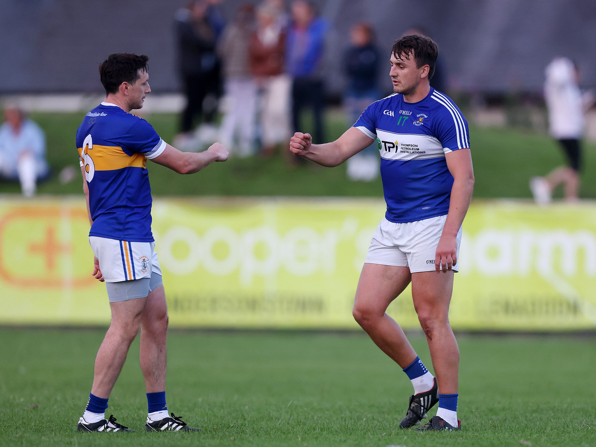 Domhnall Nugent, pictured with Rossa's Michael Armstrong after the match, had a huge influence on Wednesday night's game as St John's claimed a 0-12 to 0-9 win over their rivals