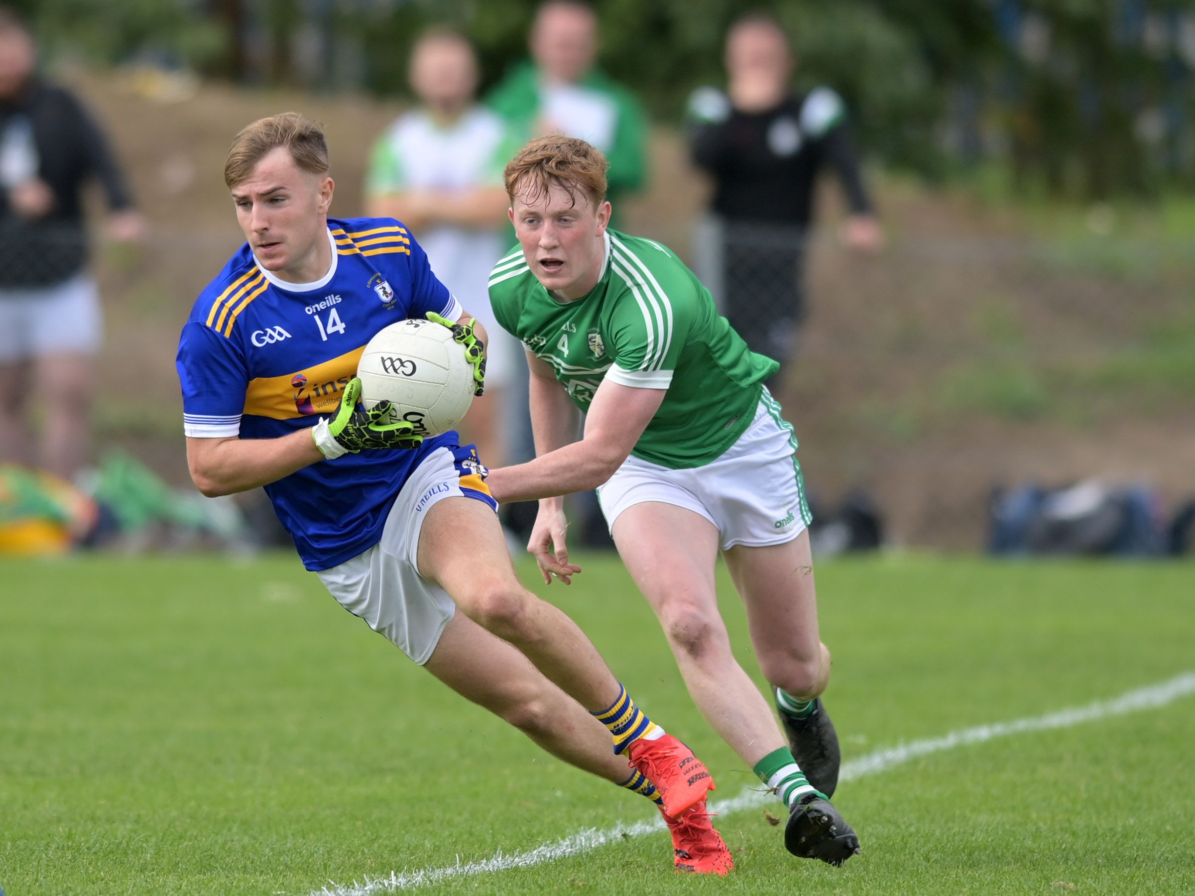 Dominic McEnhill gathers possession as Ronan Gribbin closes in