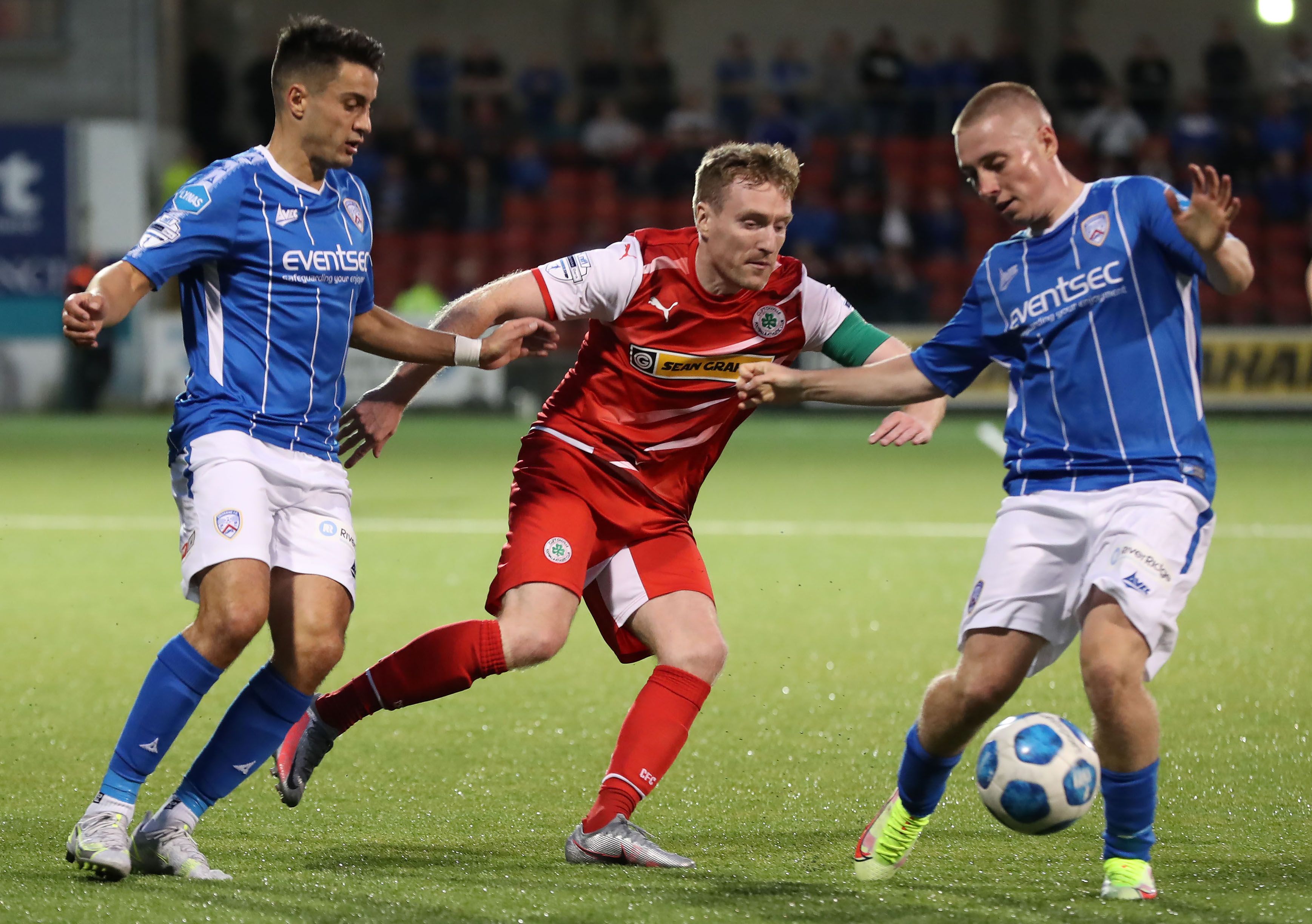 Cliftonville's Chris Curran in action with Aaron Traynor and Conor McKendry