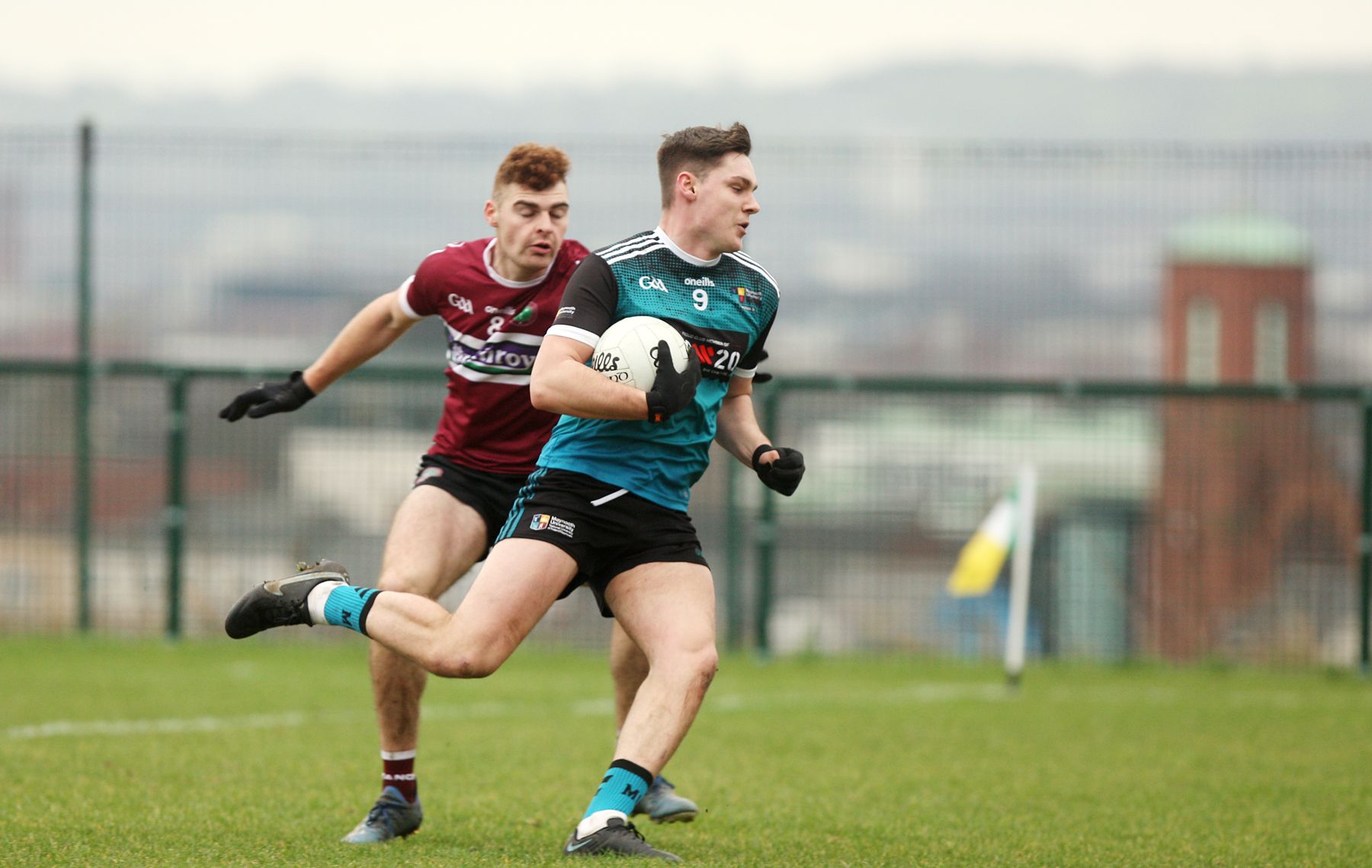Darragh Warnock bursts clear of Cormac Smyth