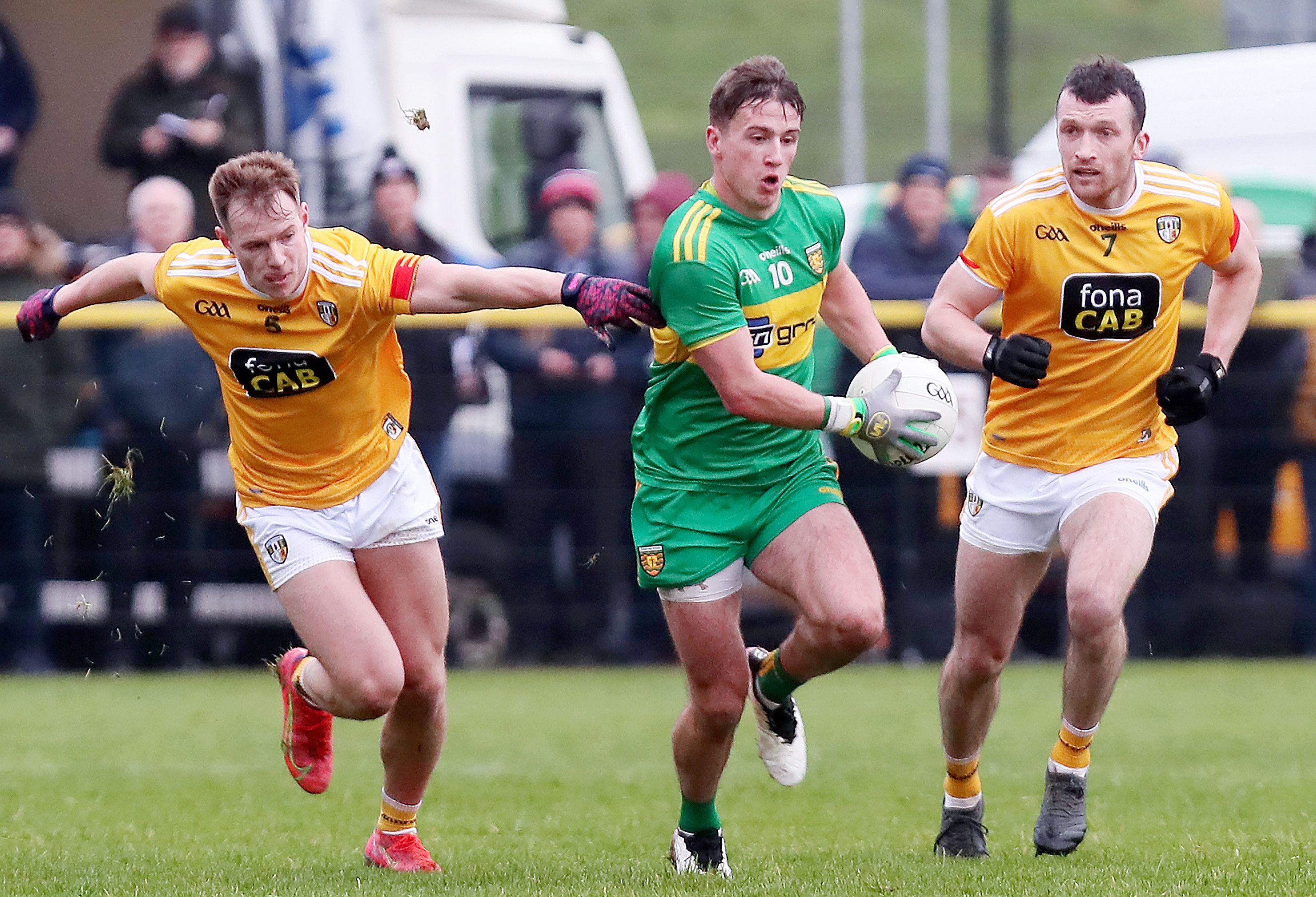 Peadar Mogan skips clear of Peter Healy and Dermott McAleese