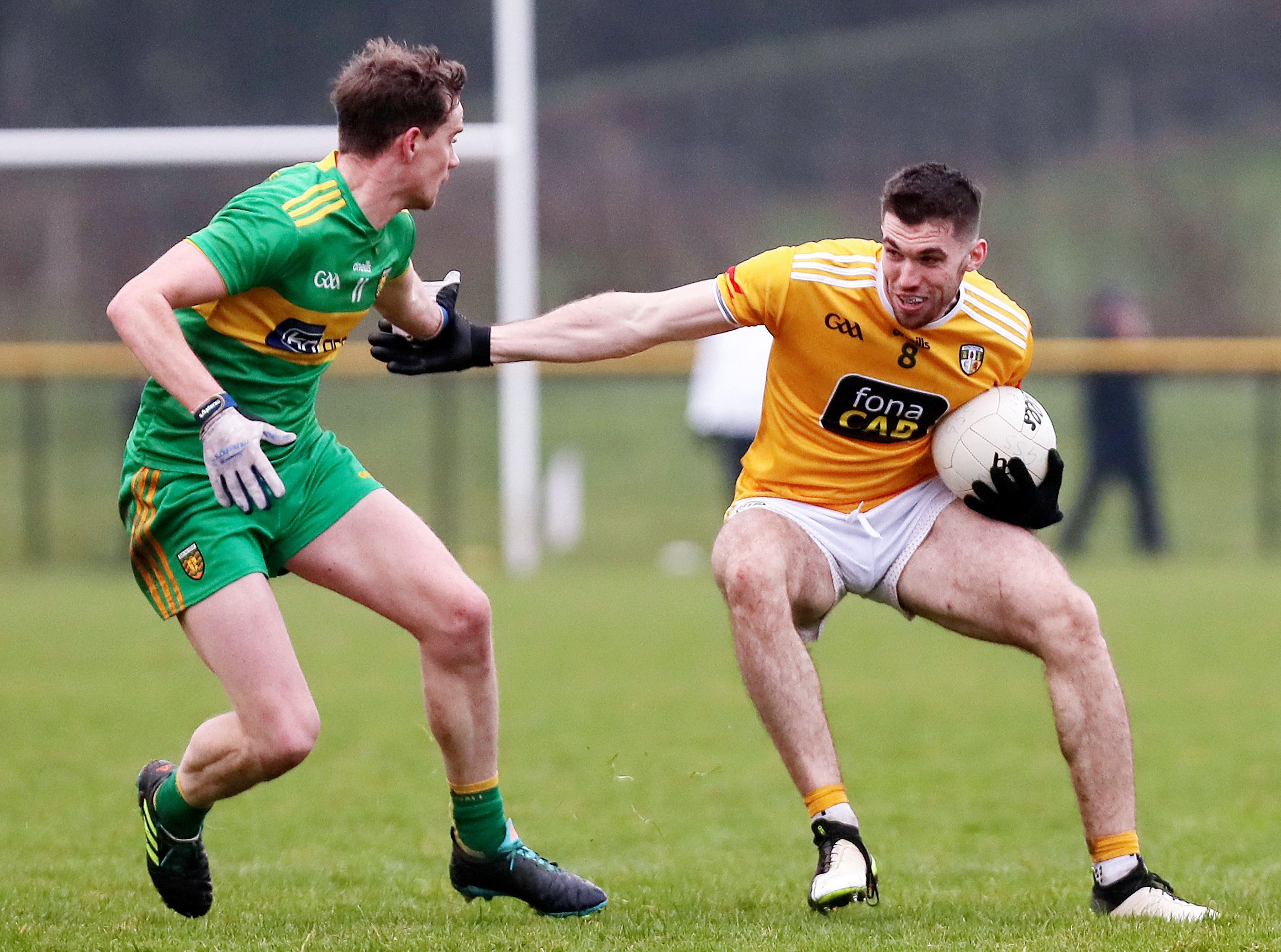 Kevin Small looks for a way around Ciaran Thompson