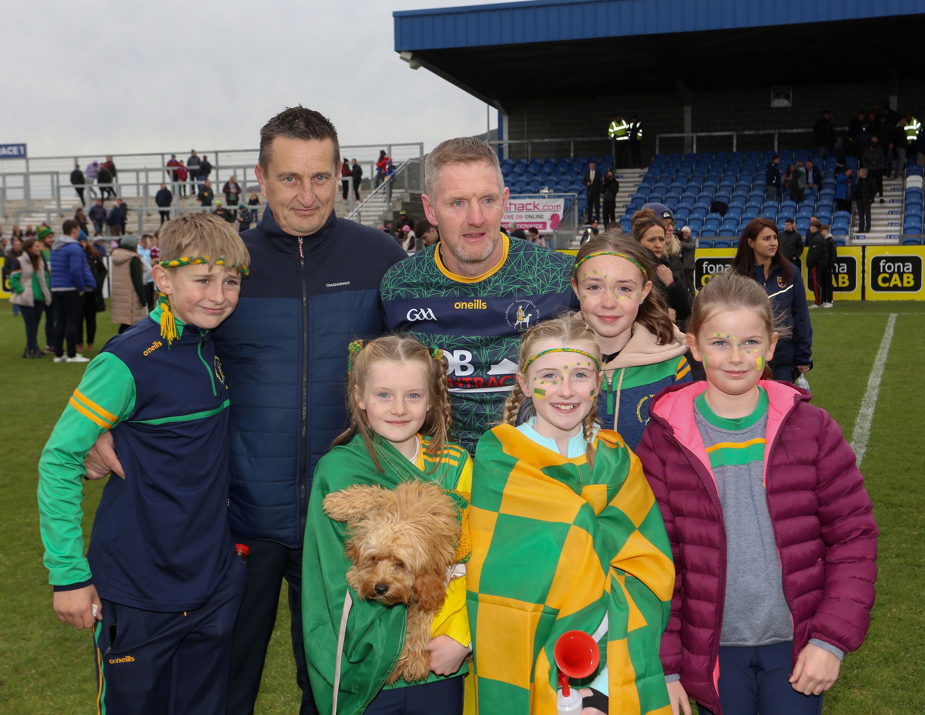 Dunloy manager Gregory O'Kane - pictured with family after Sunday's win - has now won four-in-a-row as a player and as manager with his club 