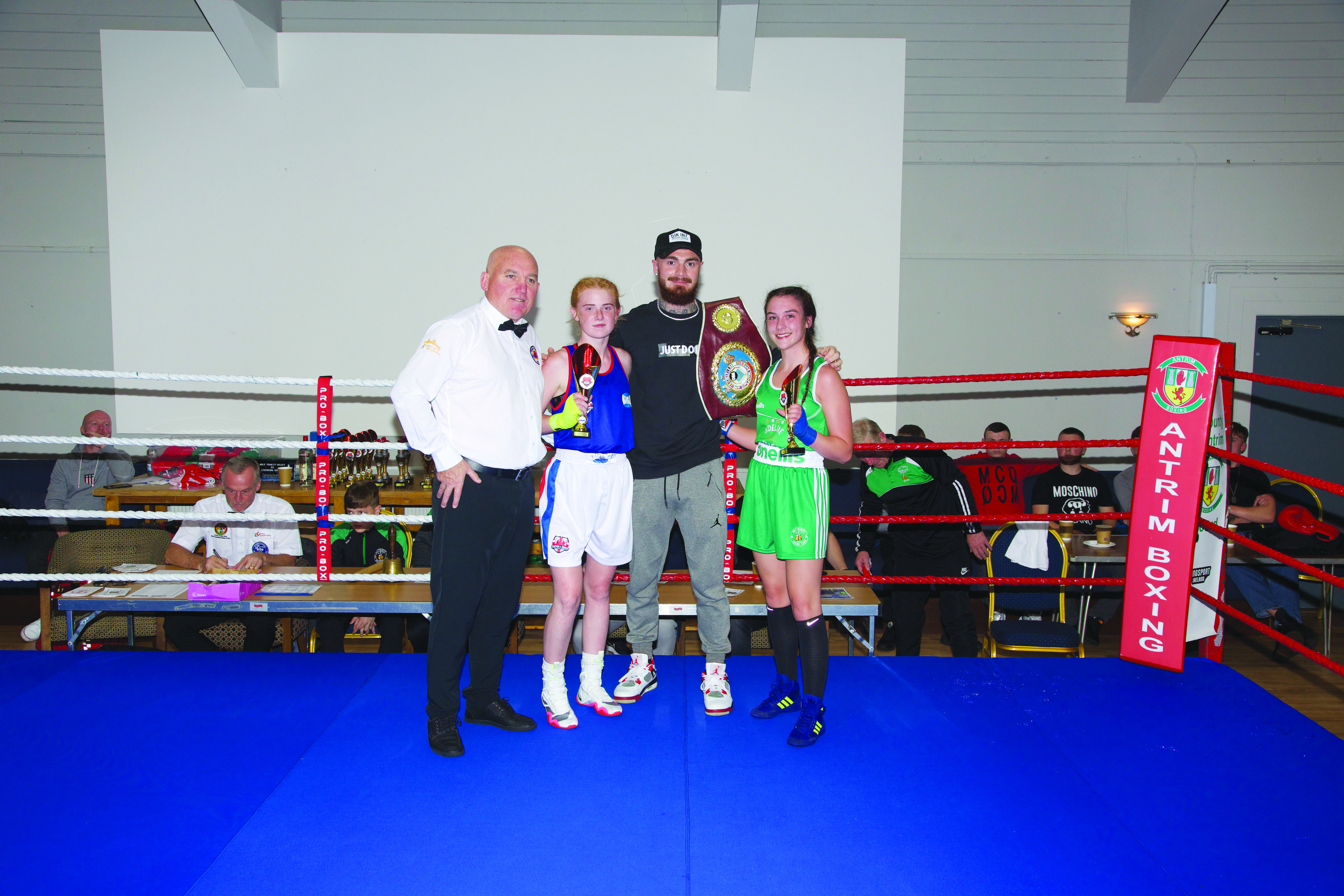 Holy Trinity star Aleesha Deronja (right) with opponent Elise Telling Shirley, referee Joe Lowe and European champion Lewis Crocker