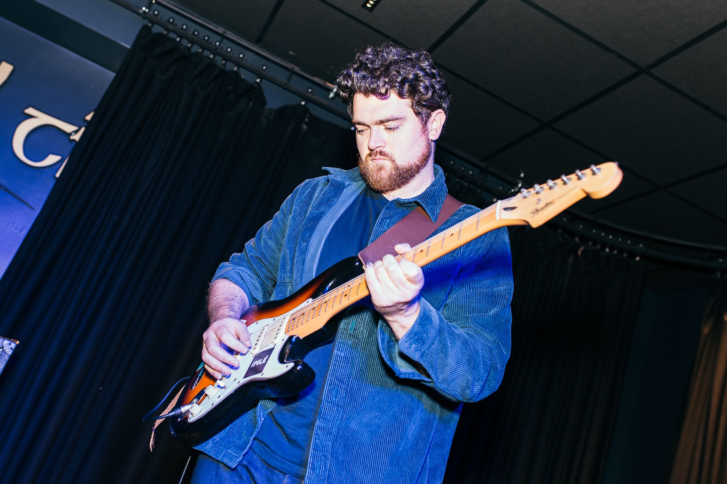 Founder Cian MacCárthaigh playing guitar