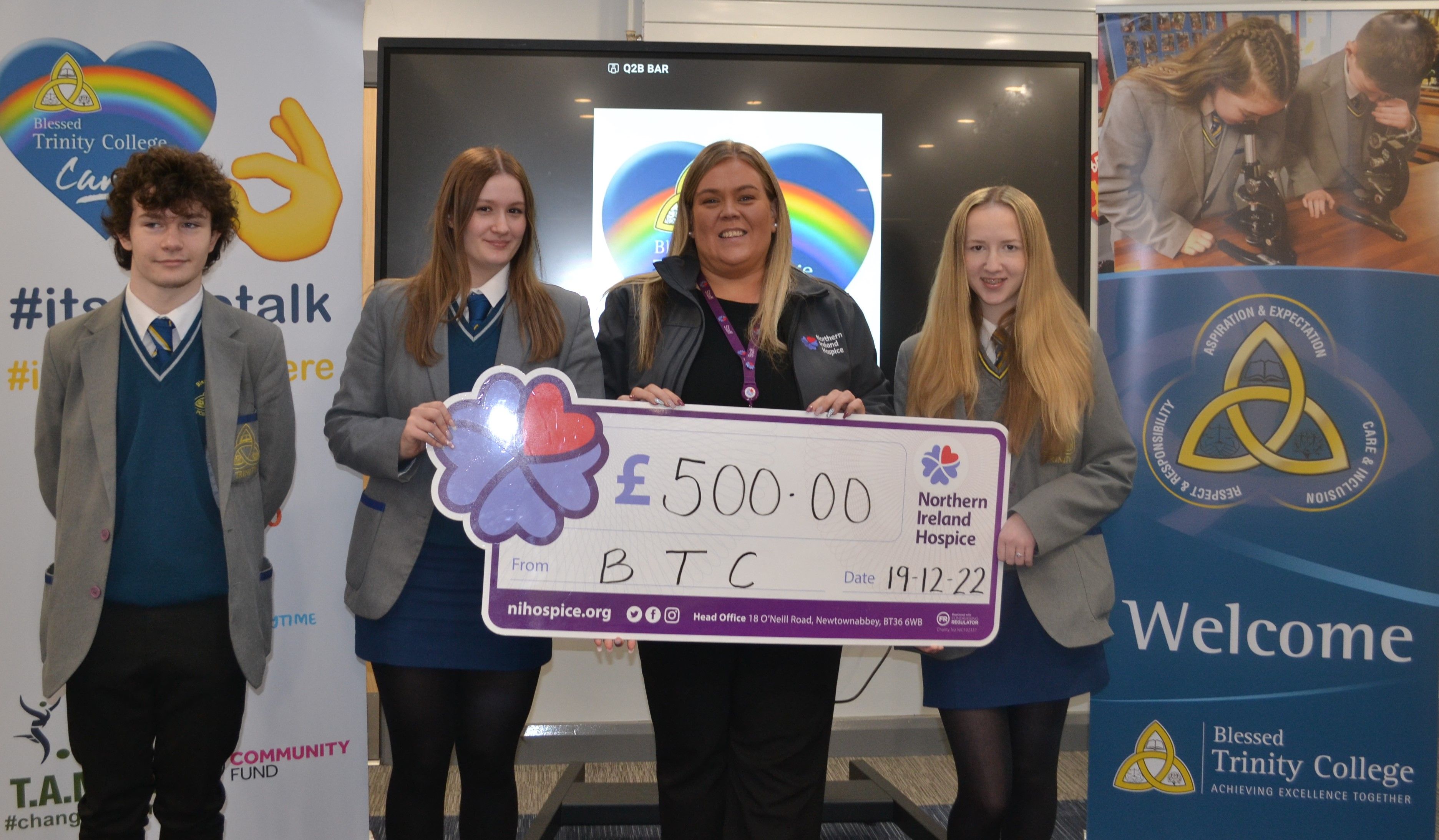 Michael, Jenni and Ciara present Leanne from NI Hospice with a cheque for £500