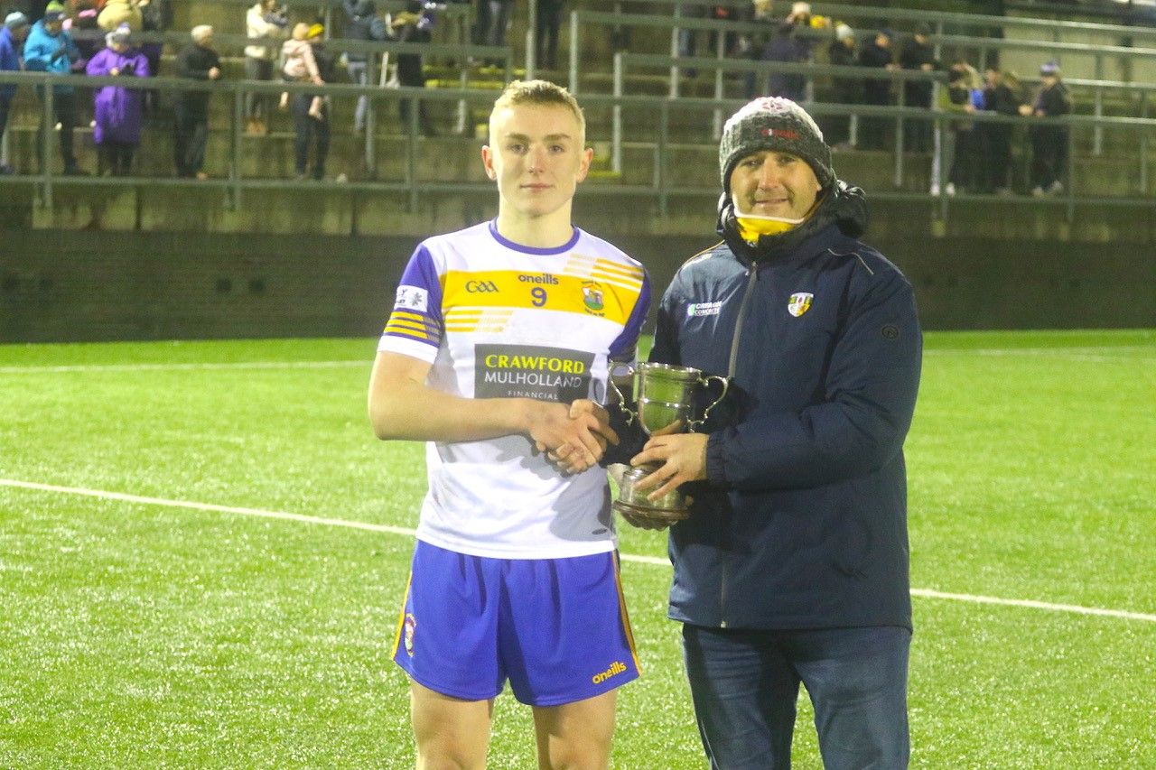 St Brigid's captain Peter Molloy and South Antrim Chairman Kevin Gamble 
