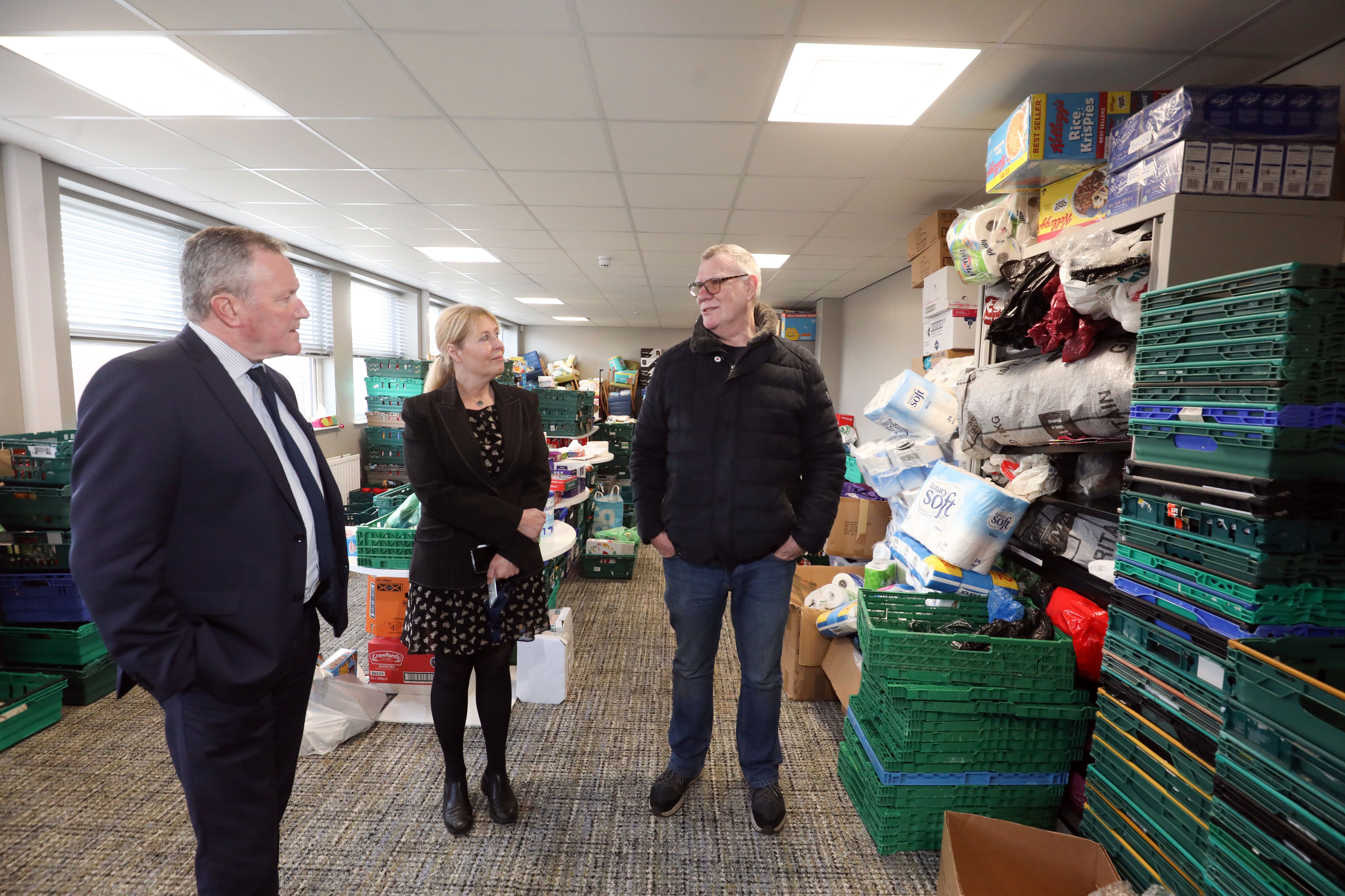 Minister Conor Murphy with Vivien Davidson and Tony Meehan during a visit to Springfield Charitable Association