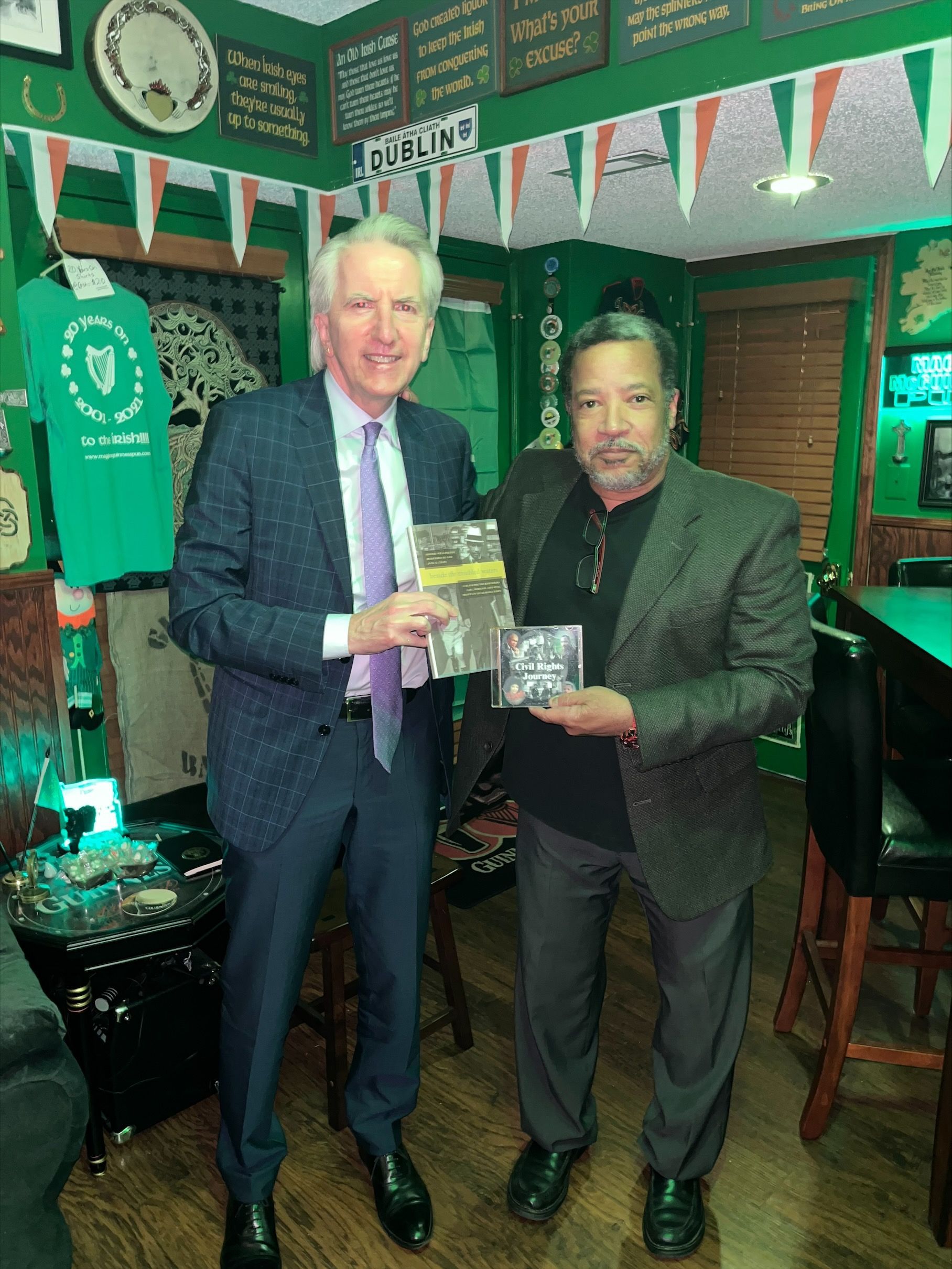 EVERYDAY A SCHOOL DAY: Sonnie Hereford, the first African American child in a public school in Alabama, presents a book and CD about his father's civil rights struggle to Máirtín Ó Muilleoir at the Maggie McGuinness' reception