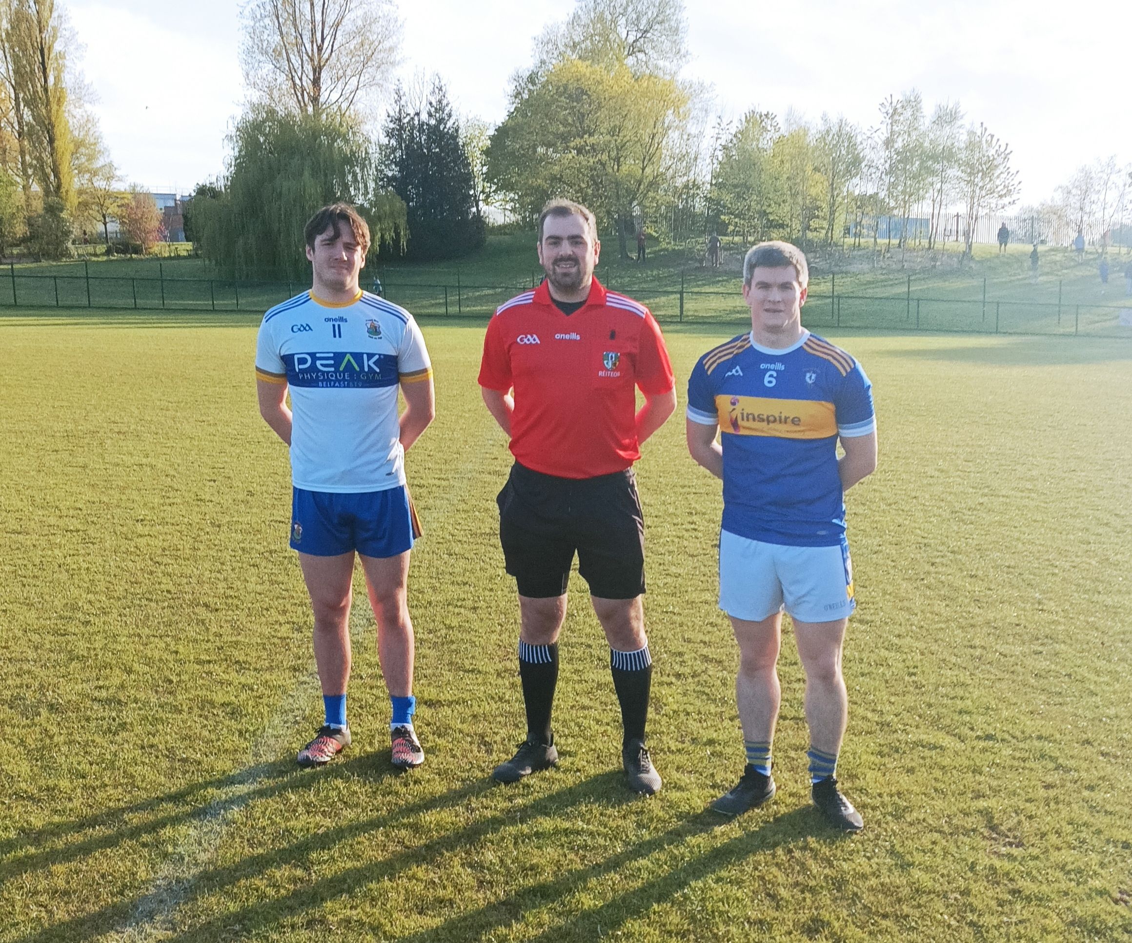 Team captains Patrick Finnegan (St Brigid's) and Chris McGuinness (Rossa) with referee Conal Roberts 