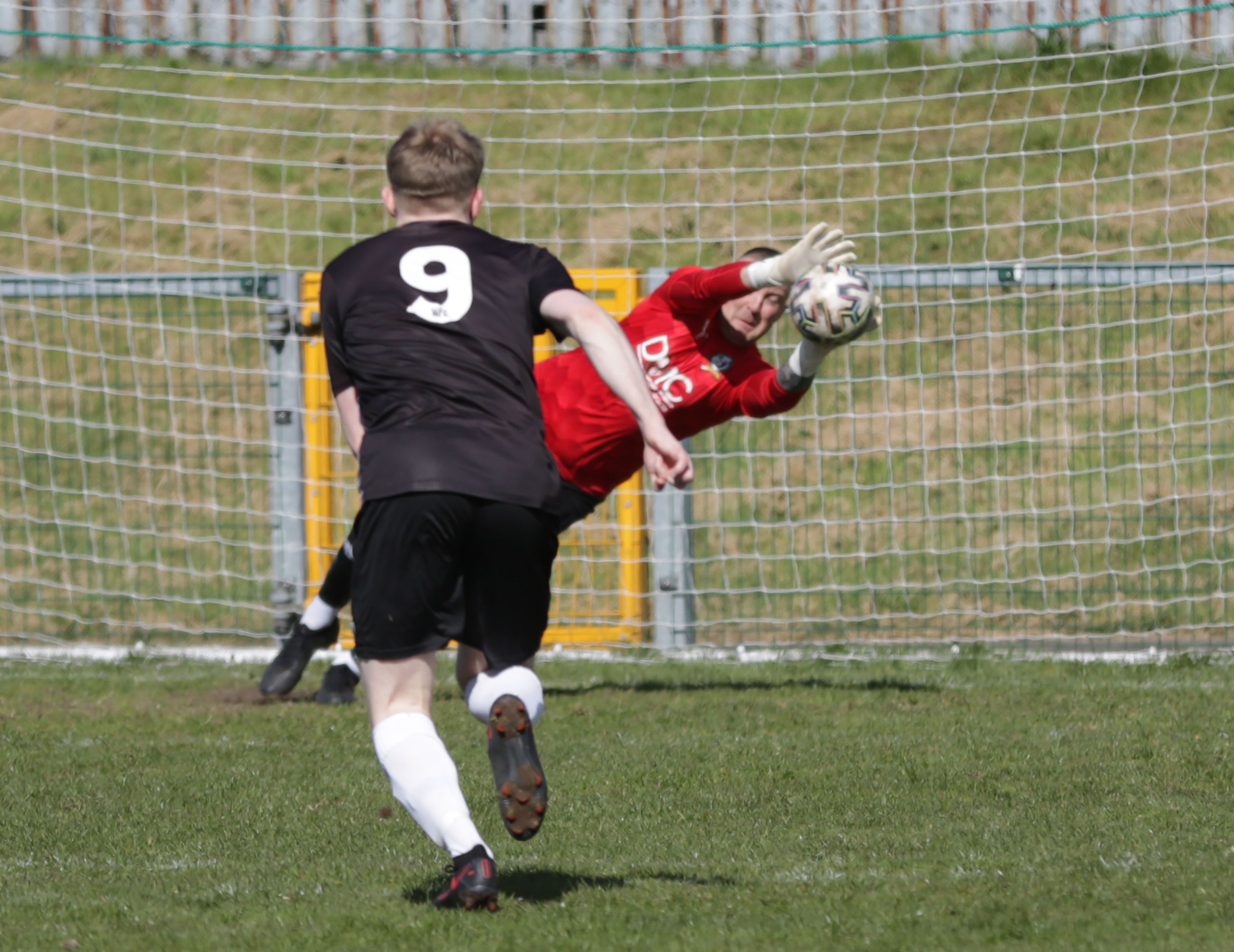 Conan Russell saves Jason Paul's penalty