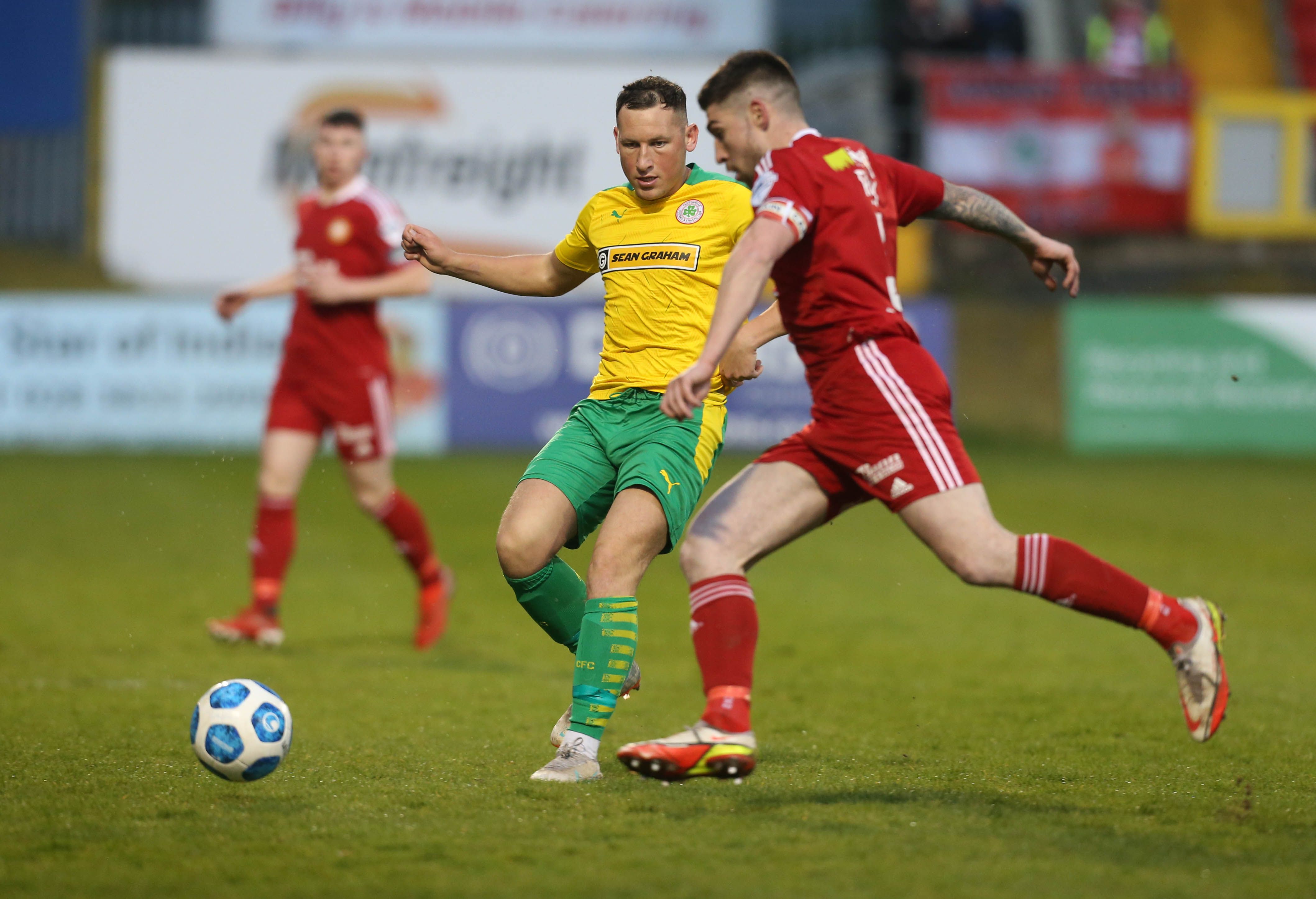 Michael Ruddy is challenged by Conor McDermott 