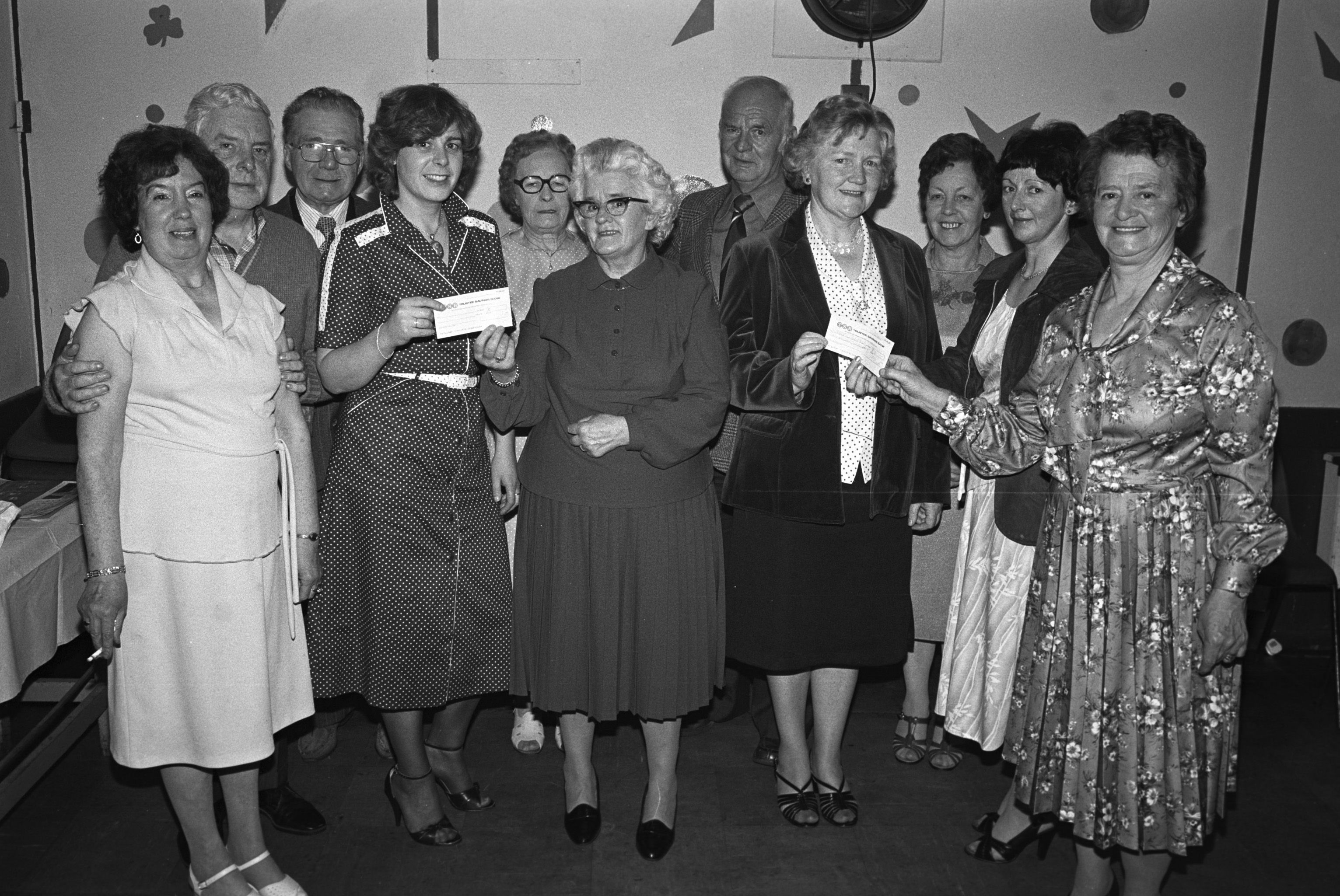 Phoebe Rock, Lower Andersonstown Thursday Club, presents a cheque to Sister Tinsley from the Royal Victoria Hospital Cardiac Unit. Patricia Armstrong hands a cheque to Sisters Armstrong and Farrell of the Maternity Unit. Also pictured are Lily Cassidy, Bobby McLaughlin, Mick McCaughey, Annie McVeigh, Bobby Oakley and Mary Brunt