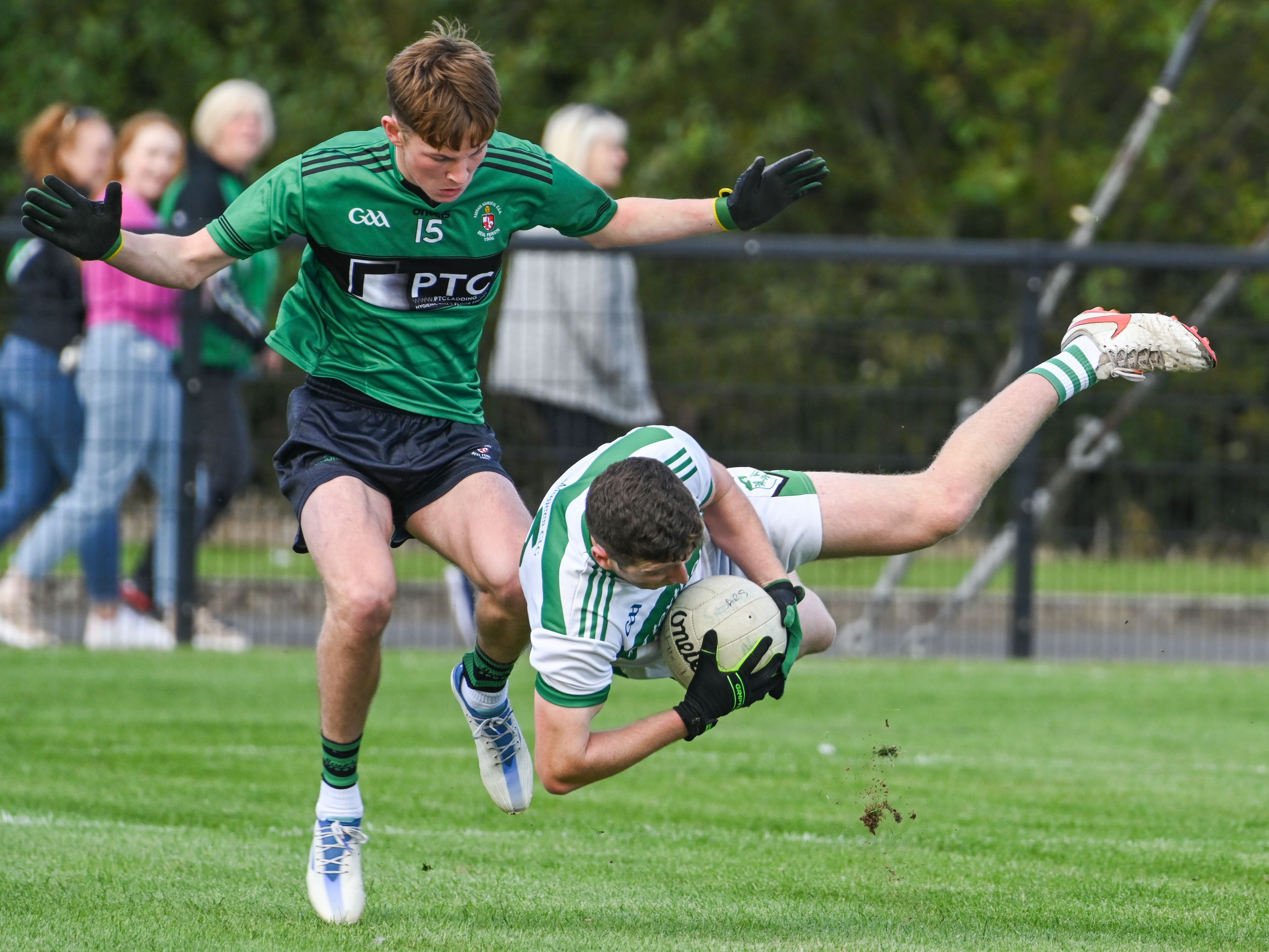 Eoin McCusker takes a tumble under Brian Healy's challenge 