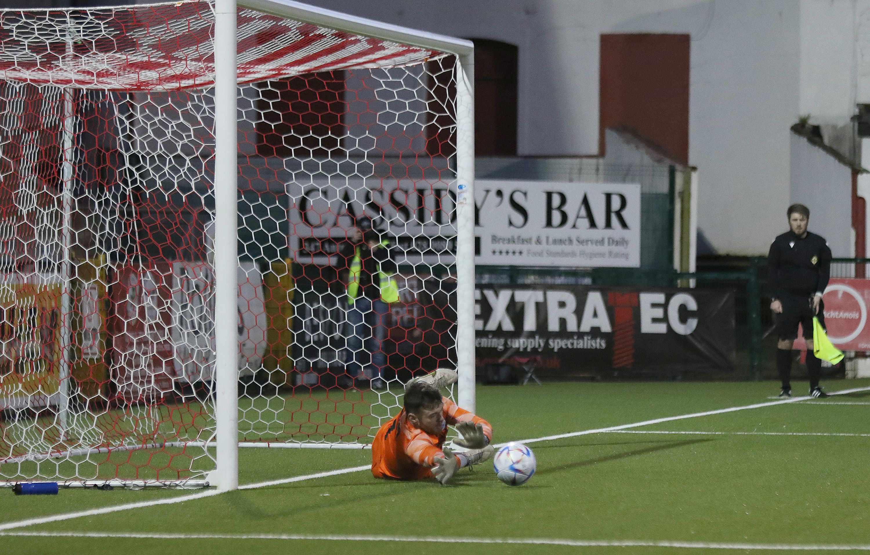 Liam Coyle saves Darren Stuart's penalty 