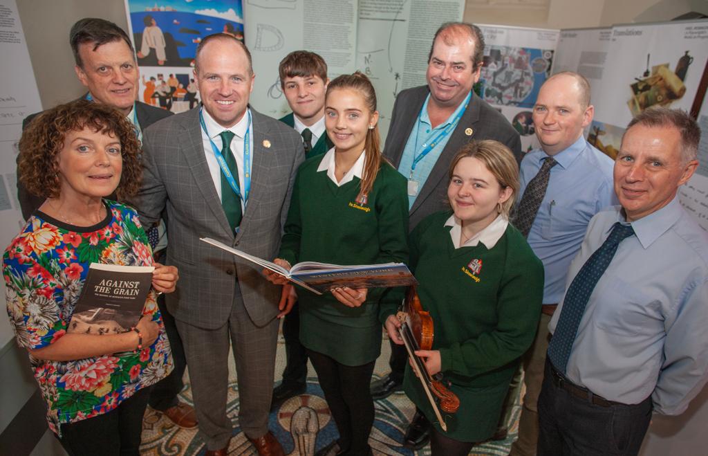 OPENING NEW CHAPTER: Senator Kennedy and colleagues from New York, Mike Carroll and Dan Dennehy, presents books about the city of Buffalo to pupils and staff at Coláiste Feirste