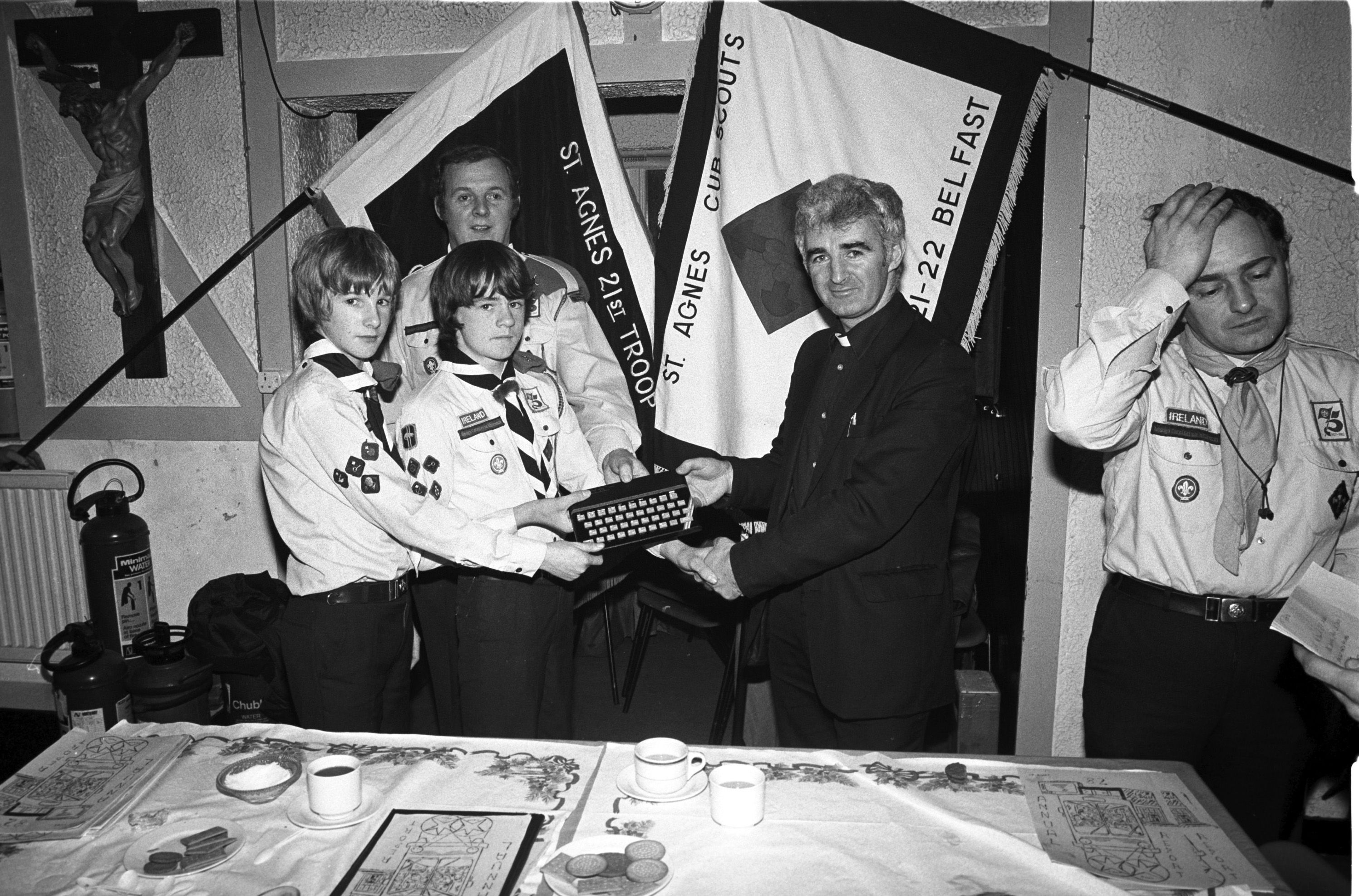 St Agnes' Cub Scouts Vincent Curley (leader), Gerard Curley and Martin Aylward present computer to Bro Dominic of La Salle