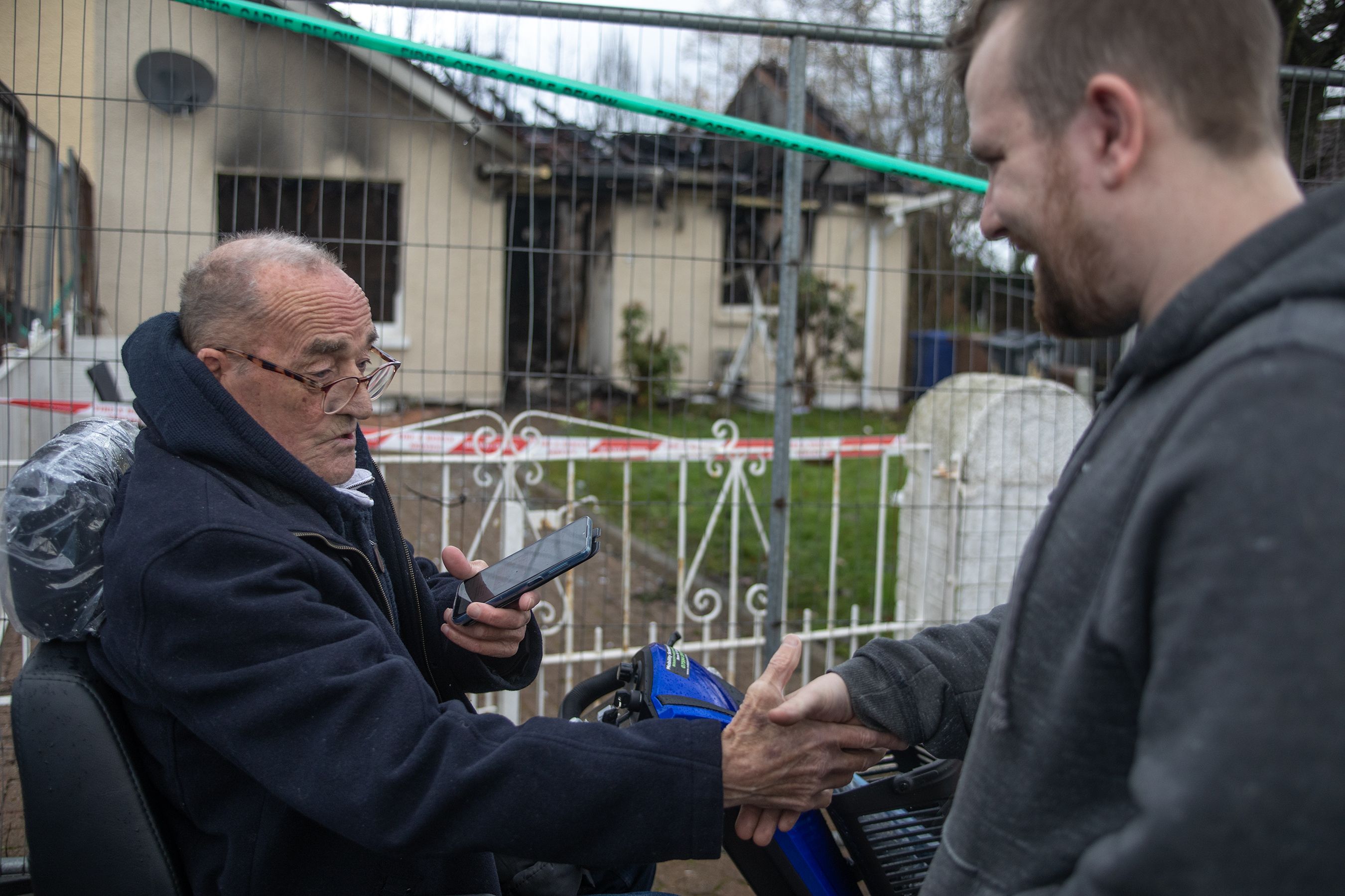 THANK YOU: Johnny McKee with neighbour Ruairi McIlroy who along with others helped him from the house