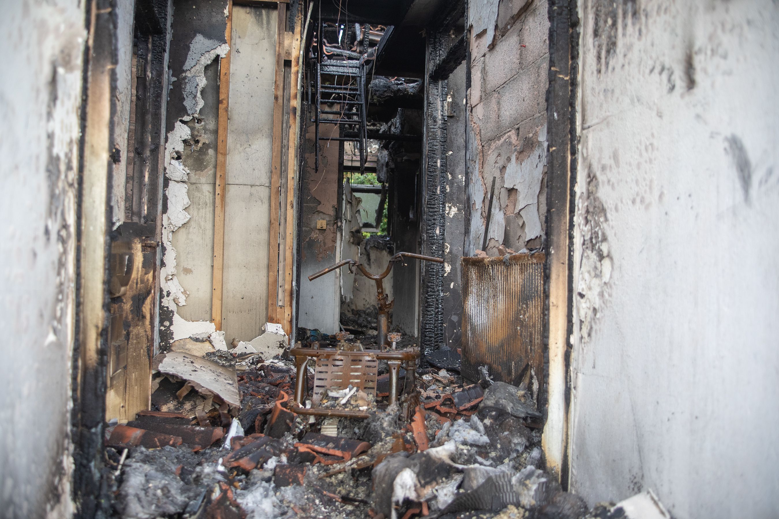 GUTTED: The remains of Johnny's mobility scooter can still be seen in the burned out home