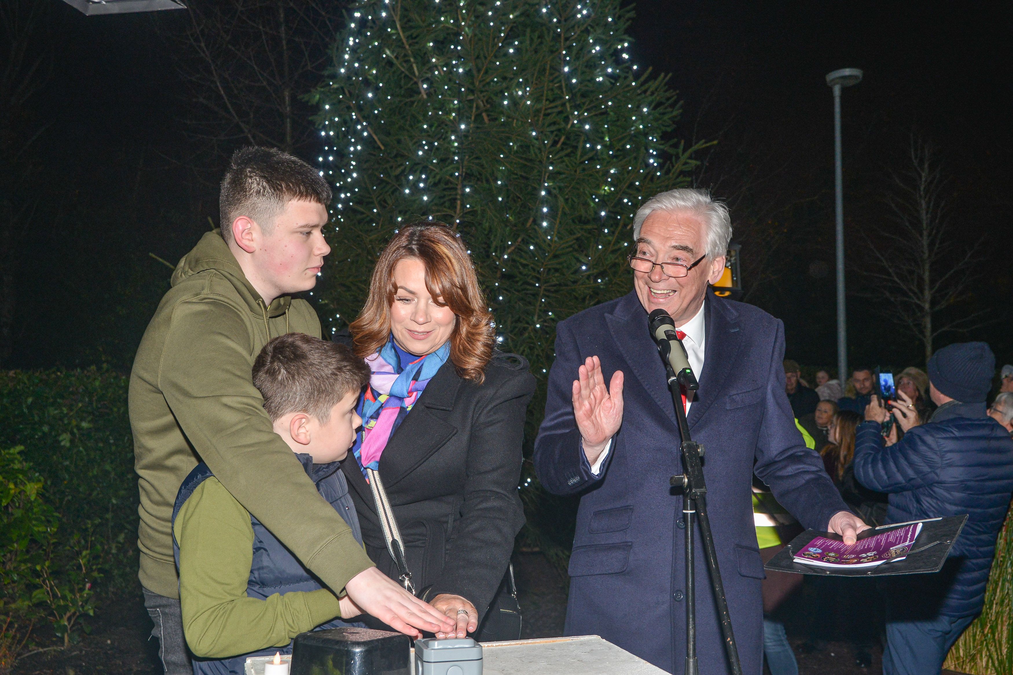 The Parkhill family switch on the Hospice lights supported by Hospice President Paul Clark