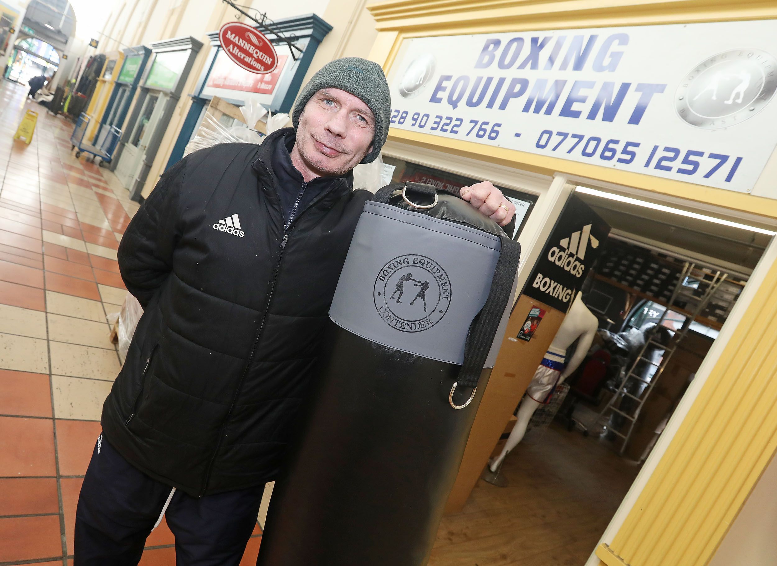 BOXING: Boxing champ Charlie Brown outside his store