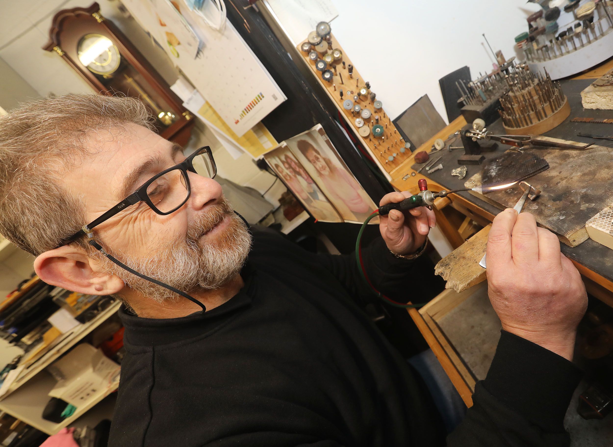 FIX IT: Abe Salami fixing a ring in his Jewellry repair shop